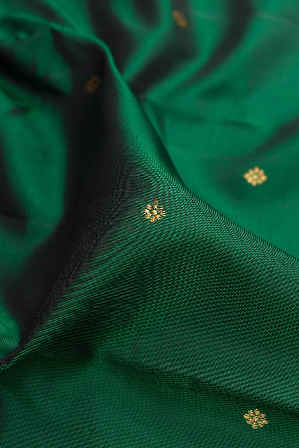Close up of Pure Silk Pure Zari Bottle Green Kanjivaram Saree with Zari Butta on the body and Fancy Border.  displaying folds