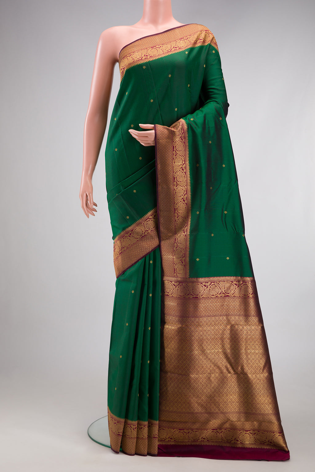 Pure Silk Pure Zari Bottle Green Kanjivaram Saree with Zari Butta on the body and Fancy Border.  displayed on a mannequin