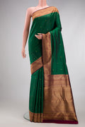Pure Silk Pure Zari Bottle Green Kanjivaram Saree with Zari Butta on the body and Fancy Border.  displayed on a mannequin