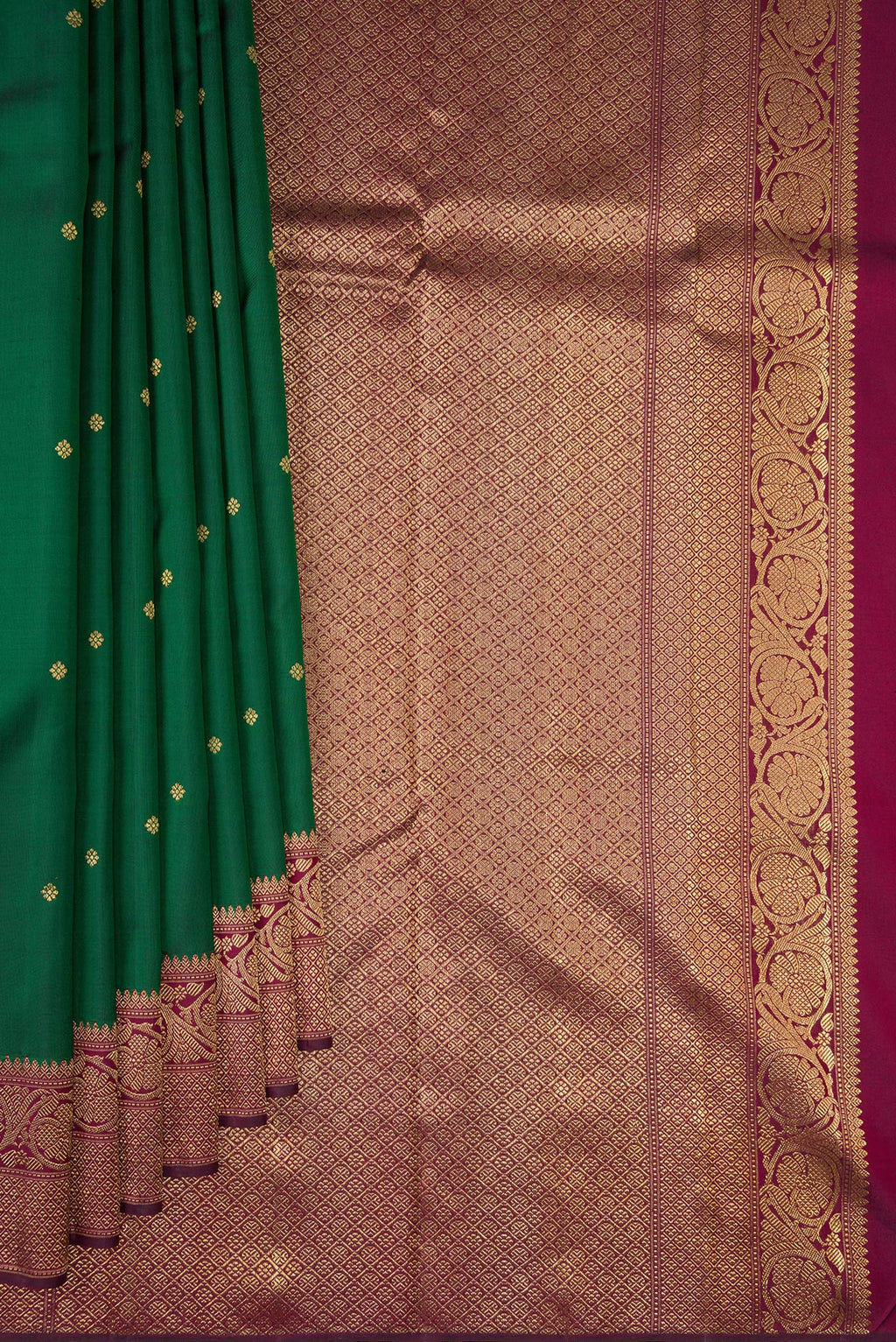 Pleats and pallu of Pure Silk Pure Zari Bottle Green Kanjivaram Saree with Zari Butta on the body and Fancy Border. 