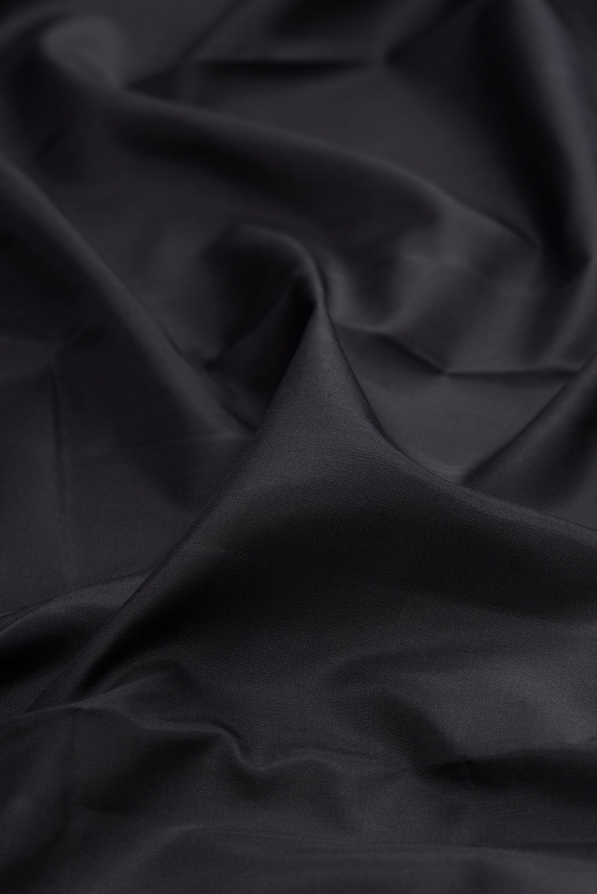 Close up of Pure Silk Pure Zari Black Kanjivaram Saree with Plain Body and Fancy Border.  displaying folds