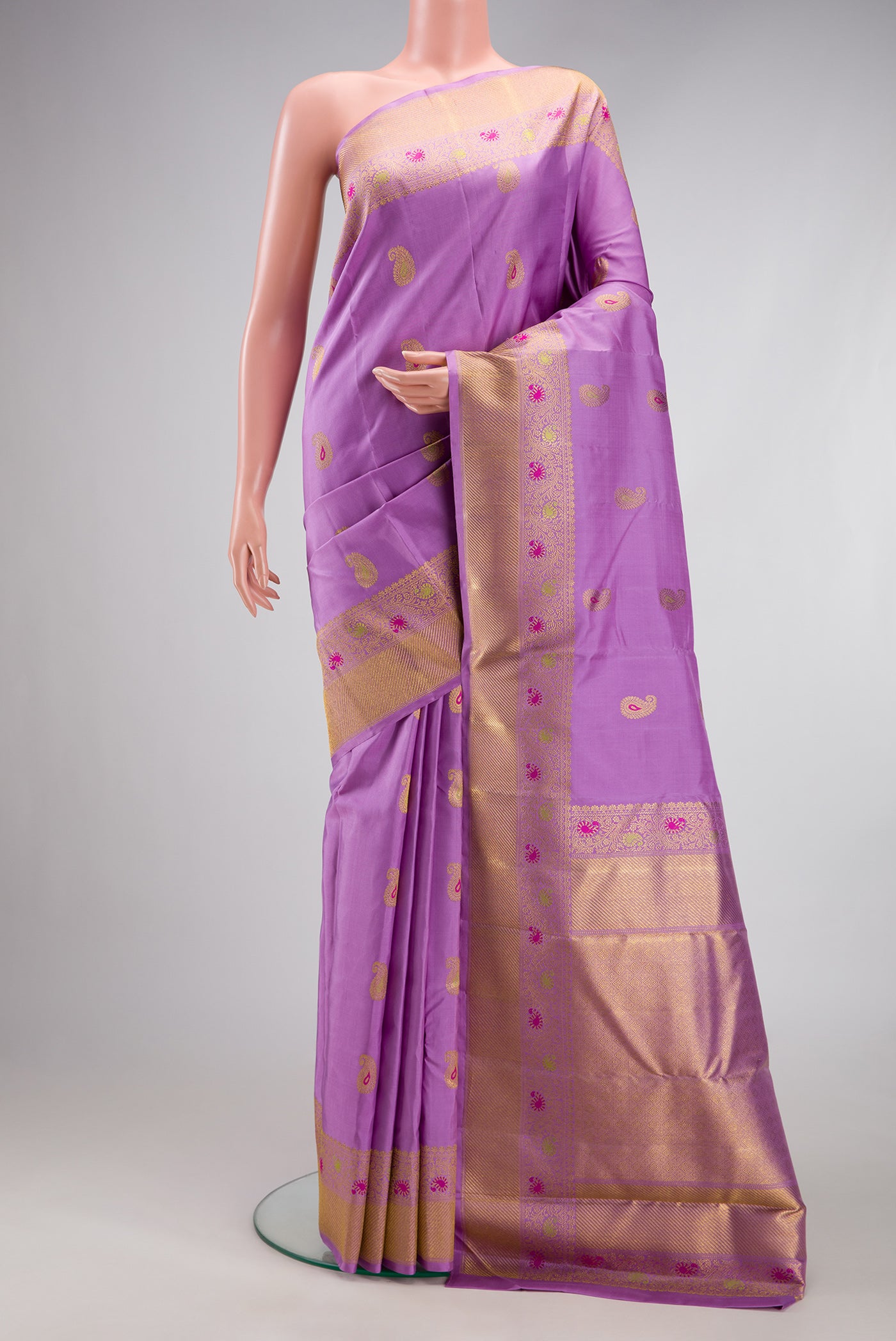 Pure Silk Pure Zari Lavender Kanjivaram Saree with Zari And Thread Butta on the body and Fancy Border.  displayed on a mannequin