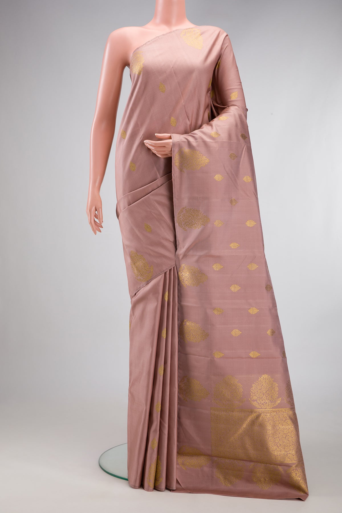 Pure Silk Pure Zari Rose Gold Kanjivaram Saree with Zari Butta on the body and Fancy Border.  displayed on a mannequin