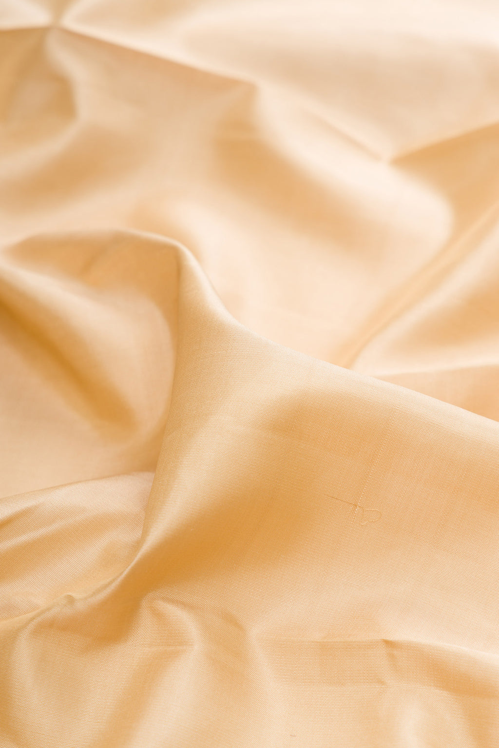 Close up of Pure Silk Pure Zari Sandal Kanjivaram Saree with Plain Body and Fancy Border.  displaying folds