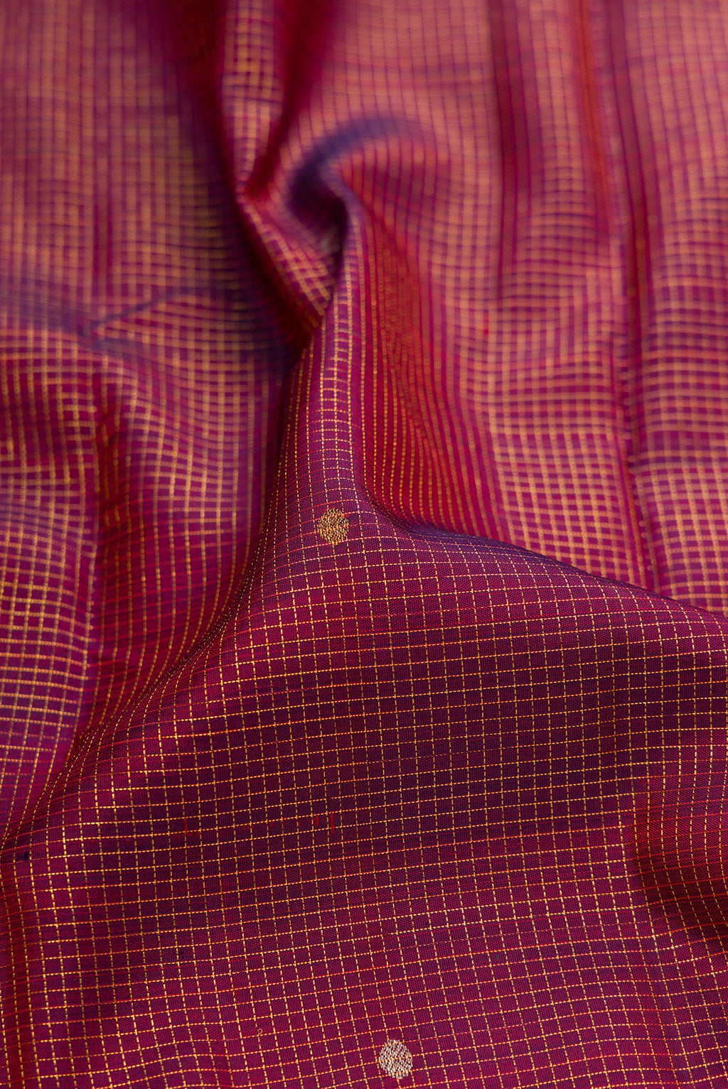 Close up of Maroon Kanjivaram Silk Saree with Checked design on the body and Temple Border.  displaying folds