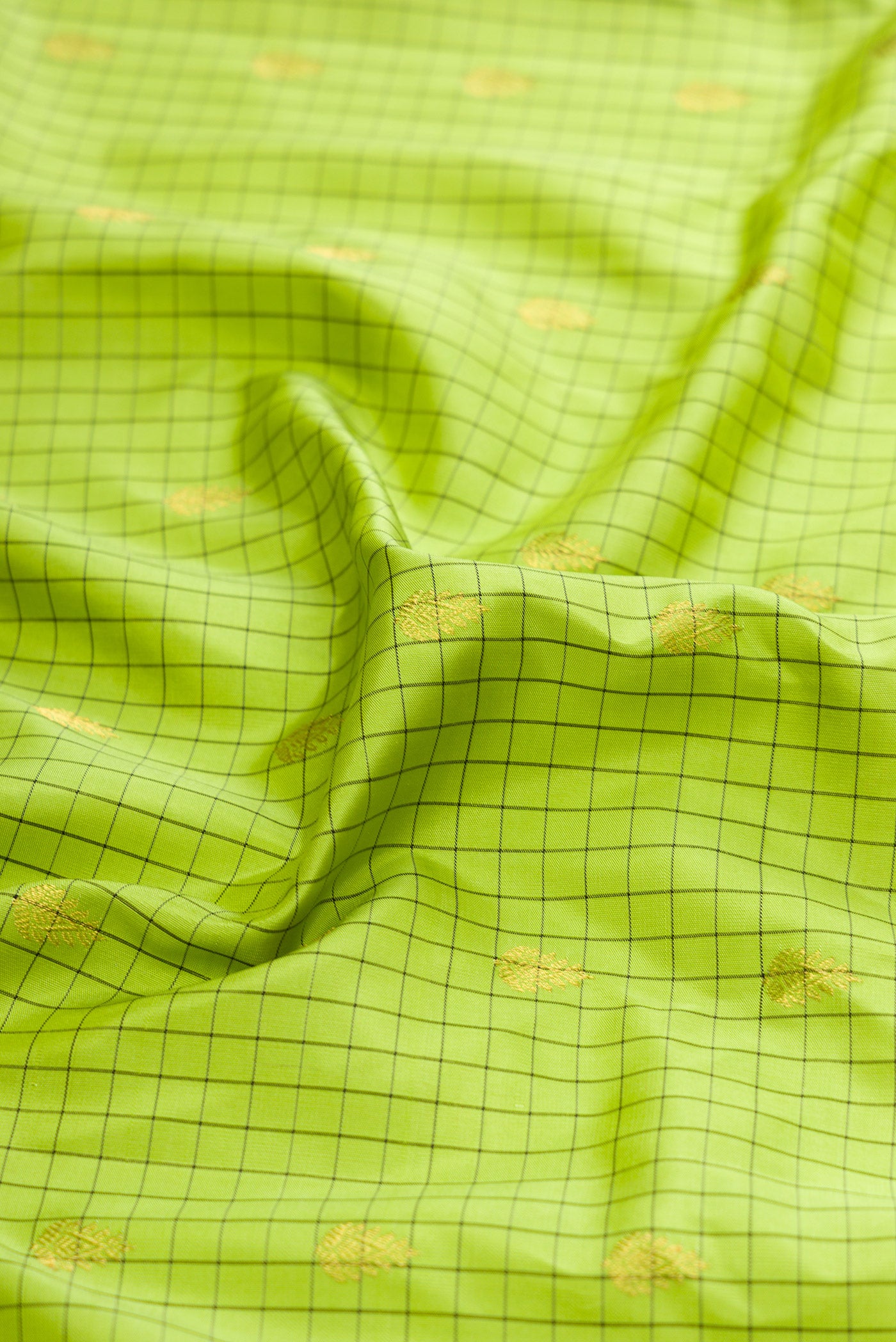 Close up of Parrot Green Gadwal Silk Saree with Checked design on the body and Zari Border.  displaying folds