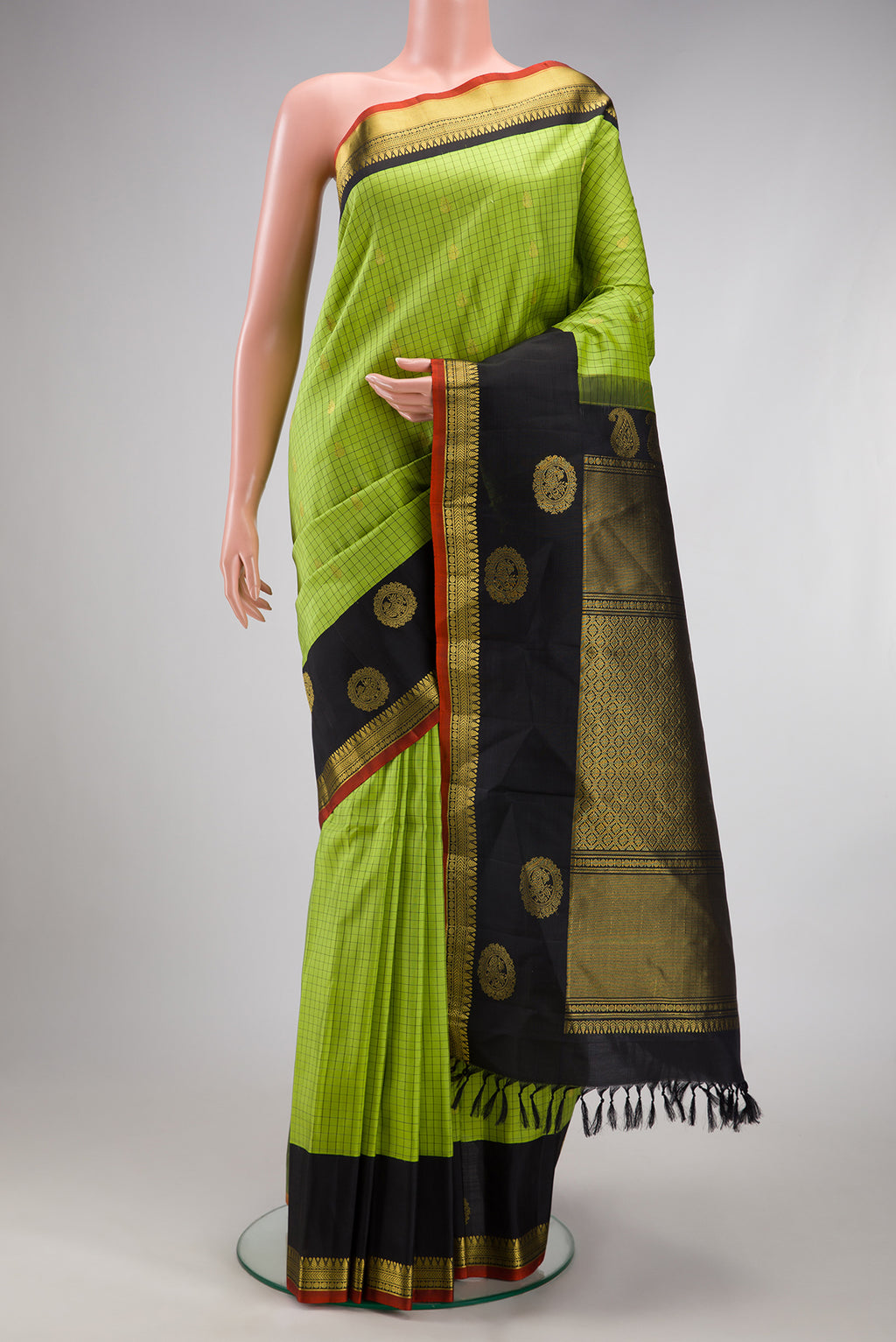 Parrot Green Gadwal Silk Saree with Checked design on the body and Zari Border.  displayed on a mannequin
