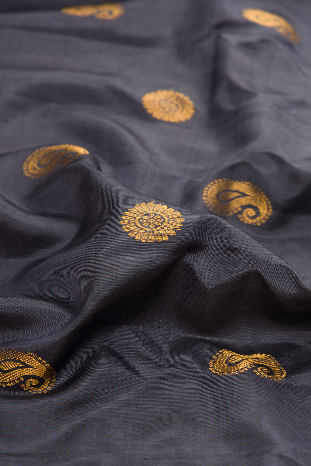 Close up of Grey Gadwal Silk Saree with Zari Butta on the body and Zari Border.  displaying folds