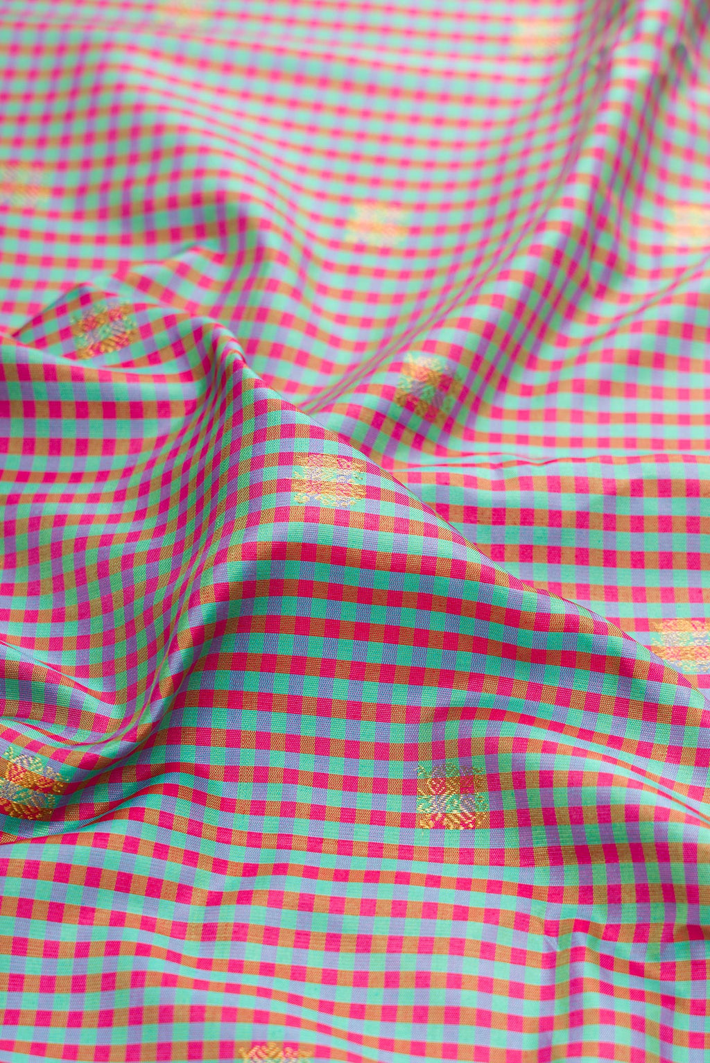 Close up of Multi Color Gadwal Silk Saree with Checked design on the body and Zari Border.  displaying folds