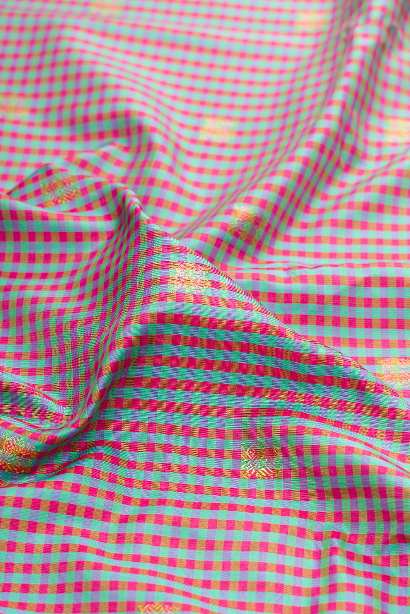Close up of Multi Color Gadwal Silk Saree with Checked design on the body and Zari Border.  displaying folds