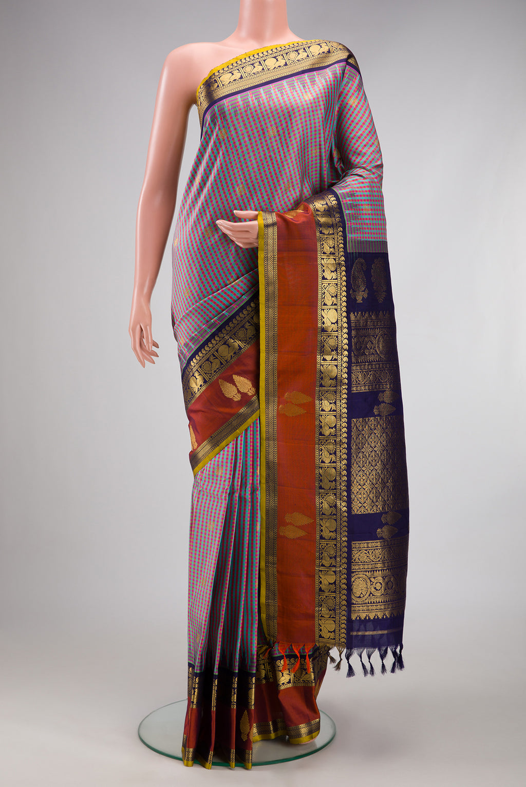 Multi Color Gadwal Silk Saree with Checked design on the body and Zari Border.  displayed on a mannequin