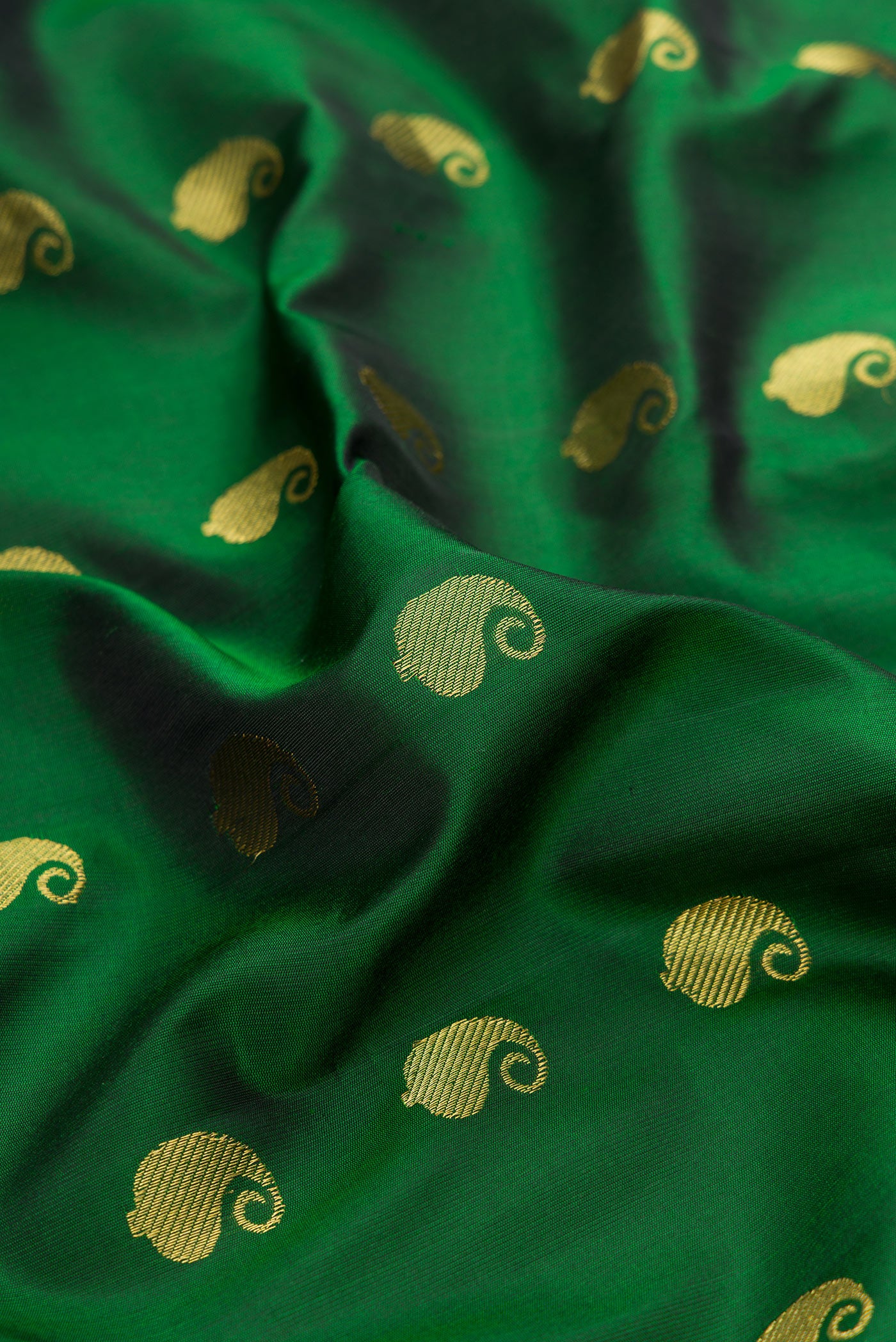 Close up of Green Gadwal Silk Saree with Zari Butta on the body and Zari Border.  displaying folds