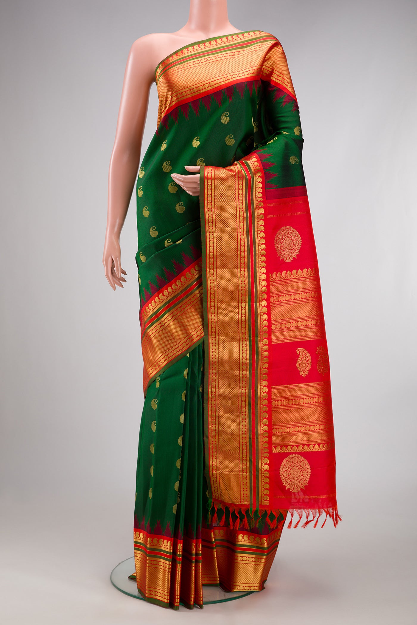 Green Gadwal Silk Saree with Zari Butta on the body and Zari Border.  displayed on a mannequin