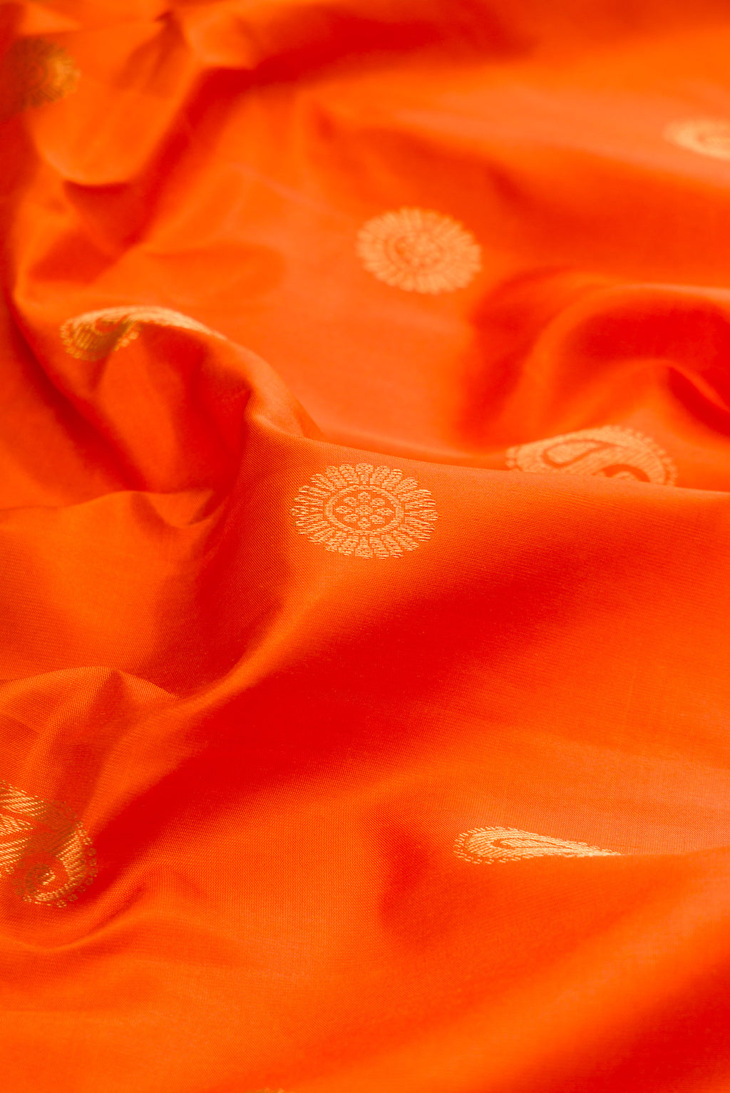 Close up of Orange Gadwal Silk Saree with Zari Butta on the body and Zari Border.  displaying folds