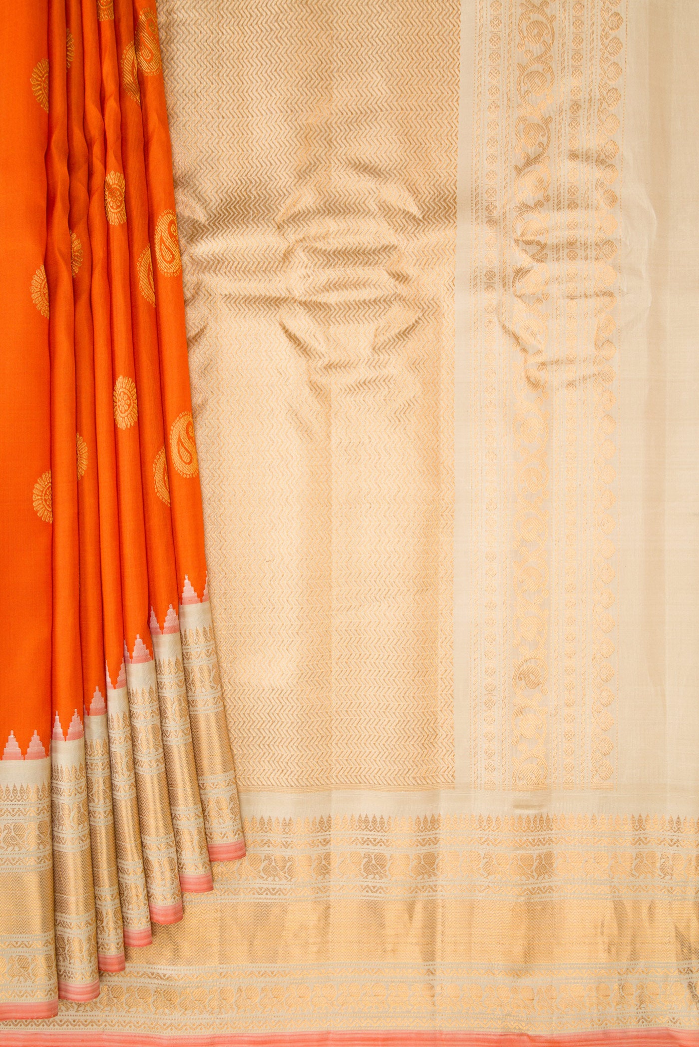 Pleats and pallu of Orange Gadwal Silk Saree with Zari Butta on the body and Zari Border. 