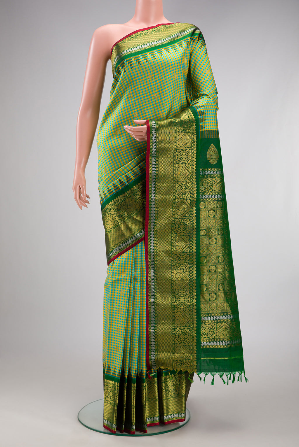 Light Green Gadwal Silk Saree with Checked design on the body and Zari Border.  displayed on a mannequin