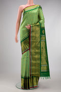 Light Green Gadwal Silk Saree with Checked design on the body and Zari Border.  displayed on a mannequin