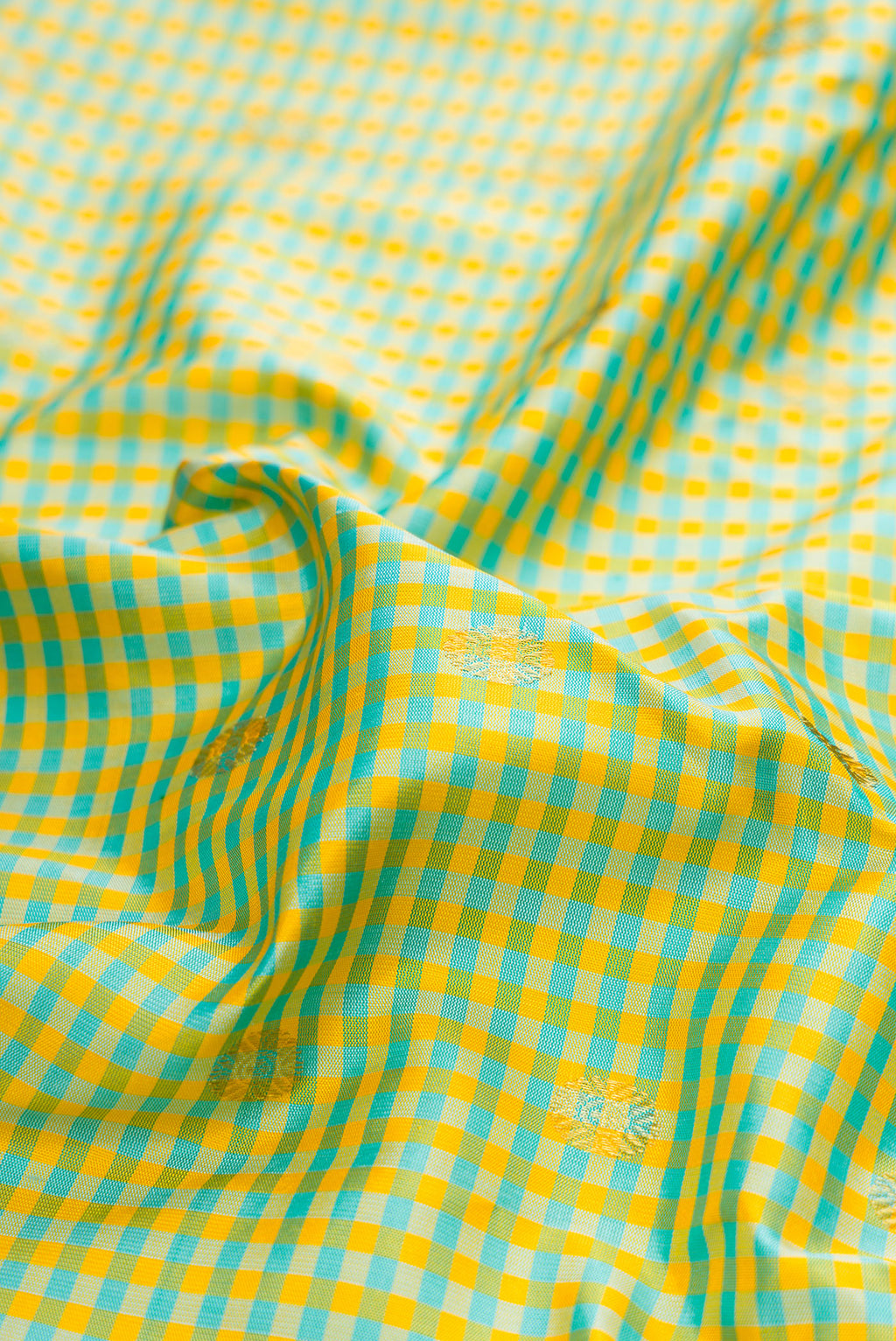 Close up of Light Green Gadwal Silk Saree with Checked design on the body and Zari Border.  displaying folds