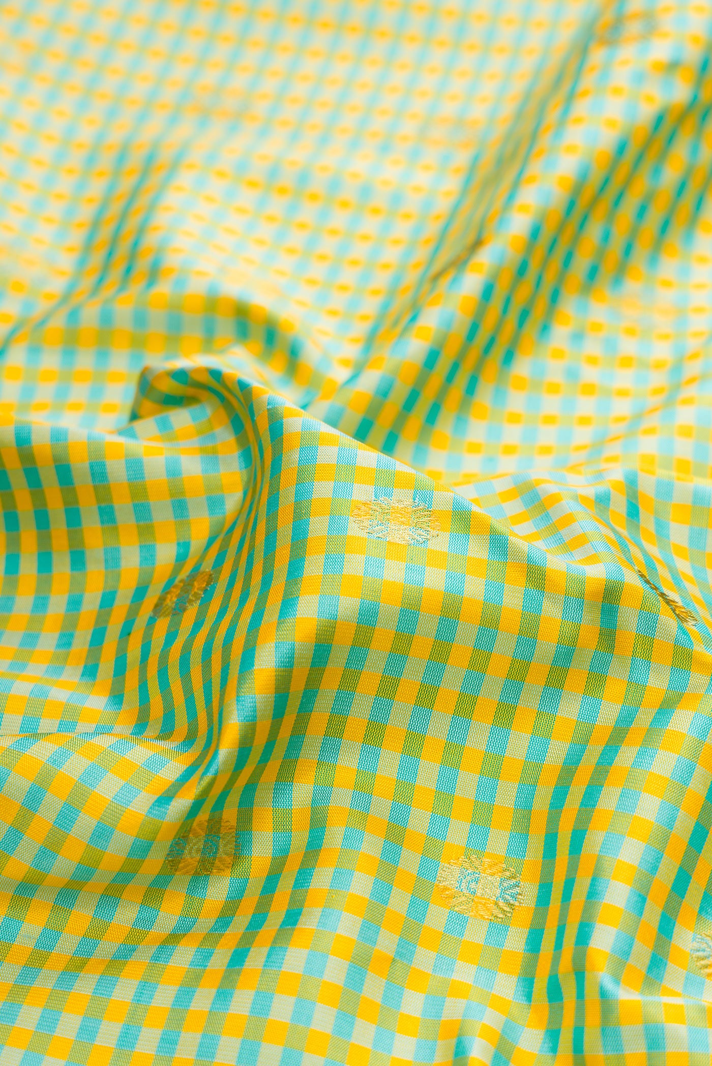 Close up of Light Green Gadwal Silk Saree with Checked design on the body and Zari Border.  displaying folds