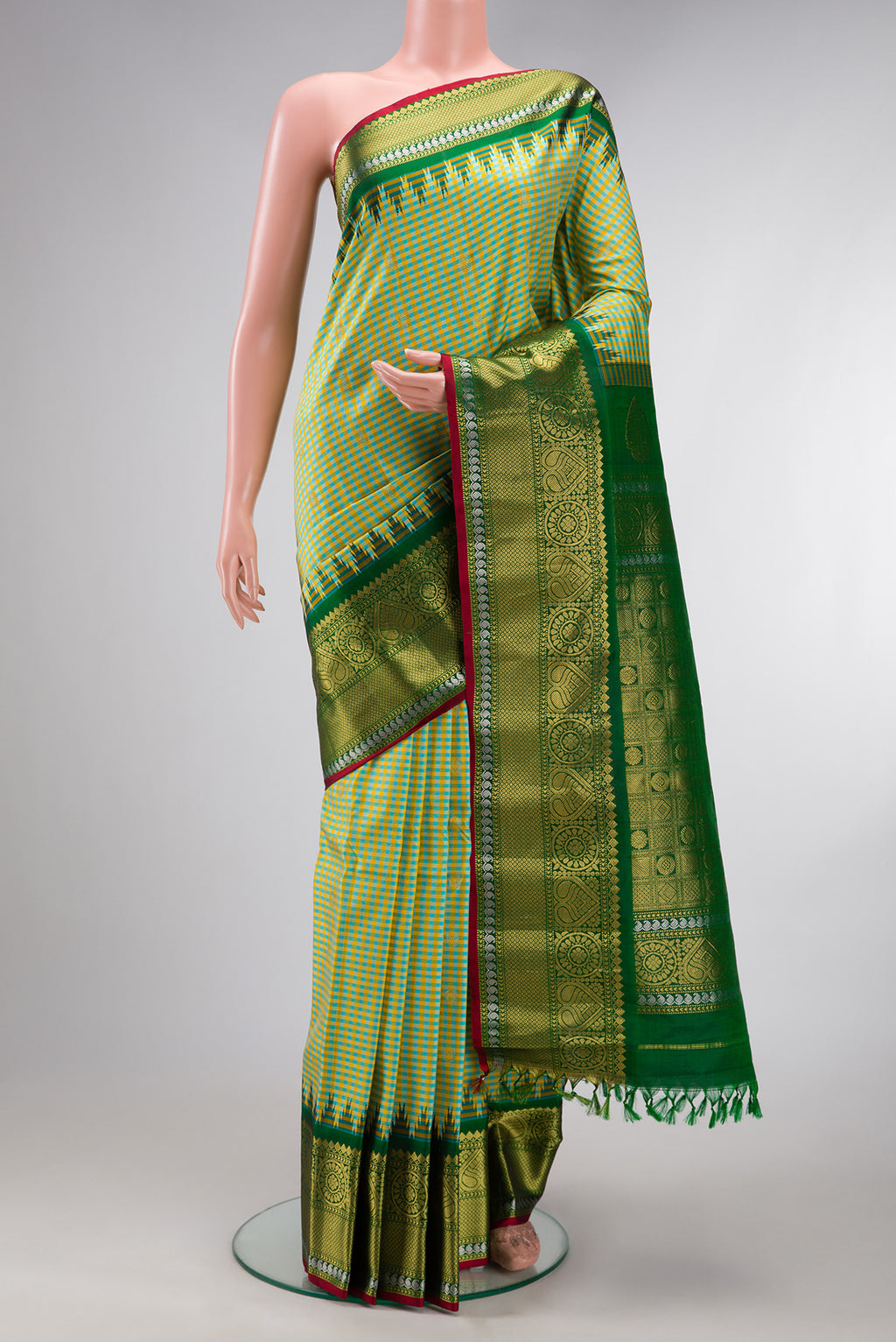 Light Green Gadwal Silk Saree with Checked design on the body and Zari Border.  displayed on a mannequin