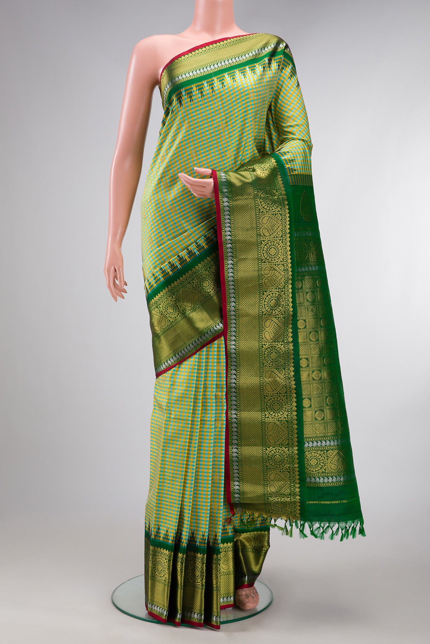 Light Green Gadwal Silk Saree with Checked design on the body and Zari Border.  displayed on a mannequin