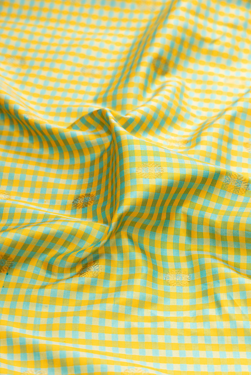 Close up of Pista Green Gadwal Silk Saree with Checked design on the body and Zari Border.  displaying folds