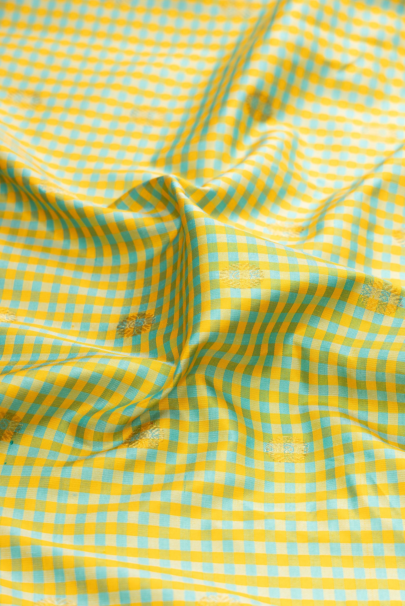 Close up of Pista Green Gadwal Silk Saree with Checked design on the body and Zari Border.  displaying folds
