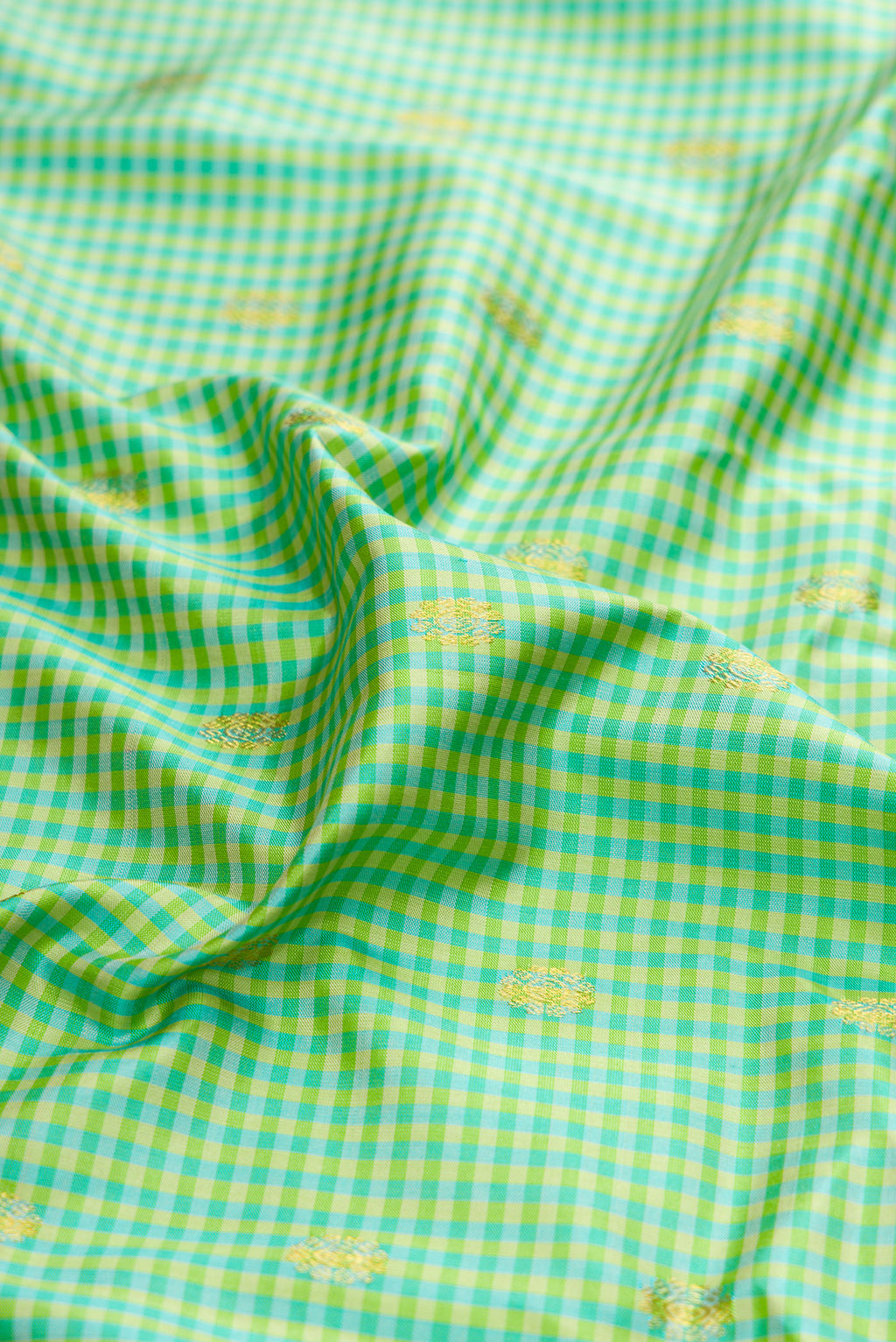 Close up of Sea Green Gadwal Silk Saree with Checked design on the body and Zari Border.  displaying folds