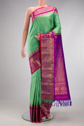 Sea Green Gadwal Silk Saree with Checked design on the body and Zari Border.  displayed on a mannequin