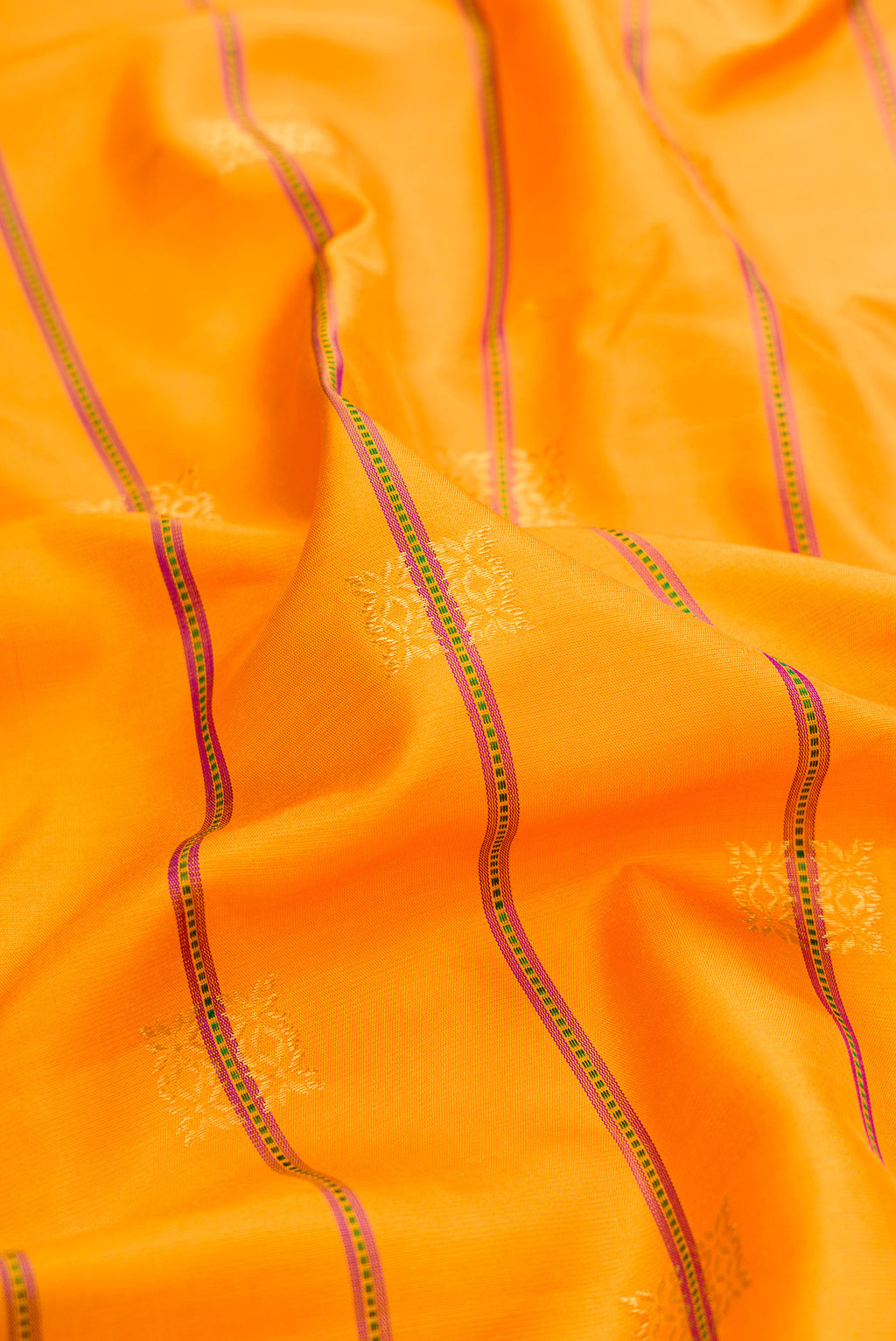 Close up of Yellow Gadwal Silk Saree with Stripes on the body and Zari Border.  displaying folds