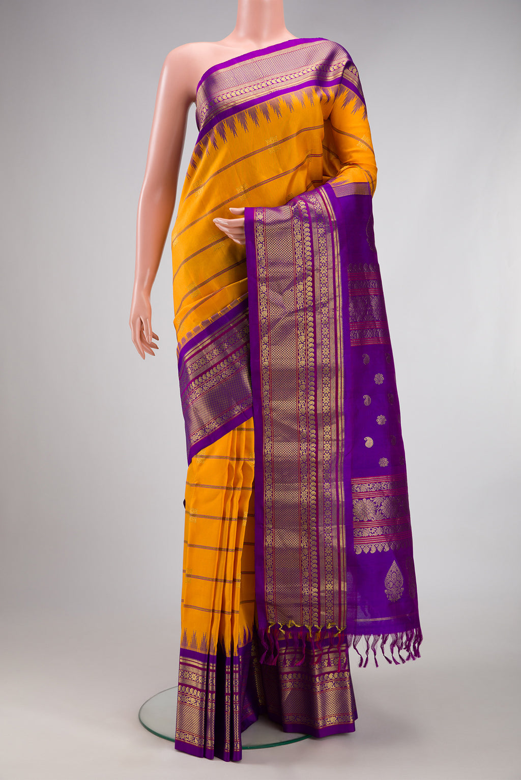 Yellow Gadwal Silk Saree with Stripes on the body and Zari Border.  displayed on a mannequin
