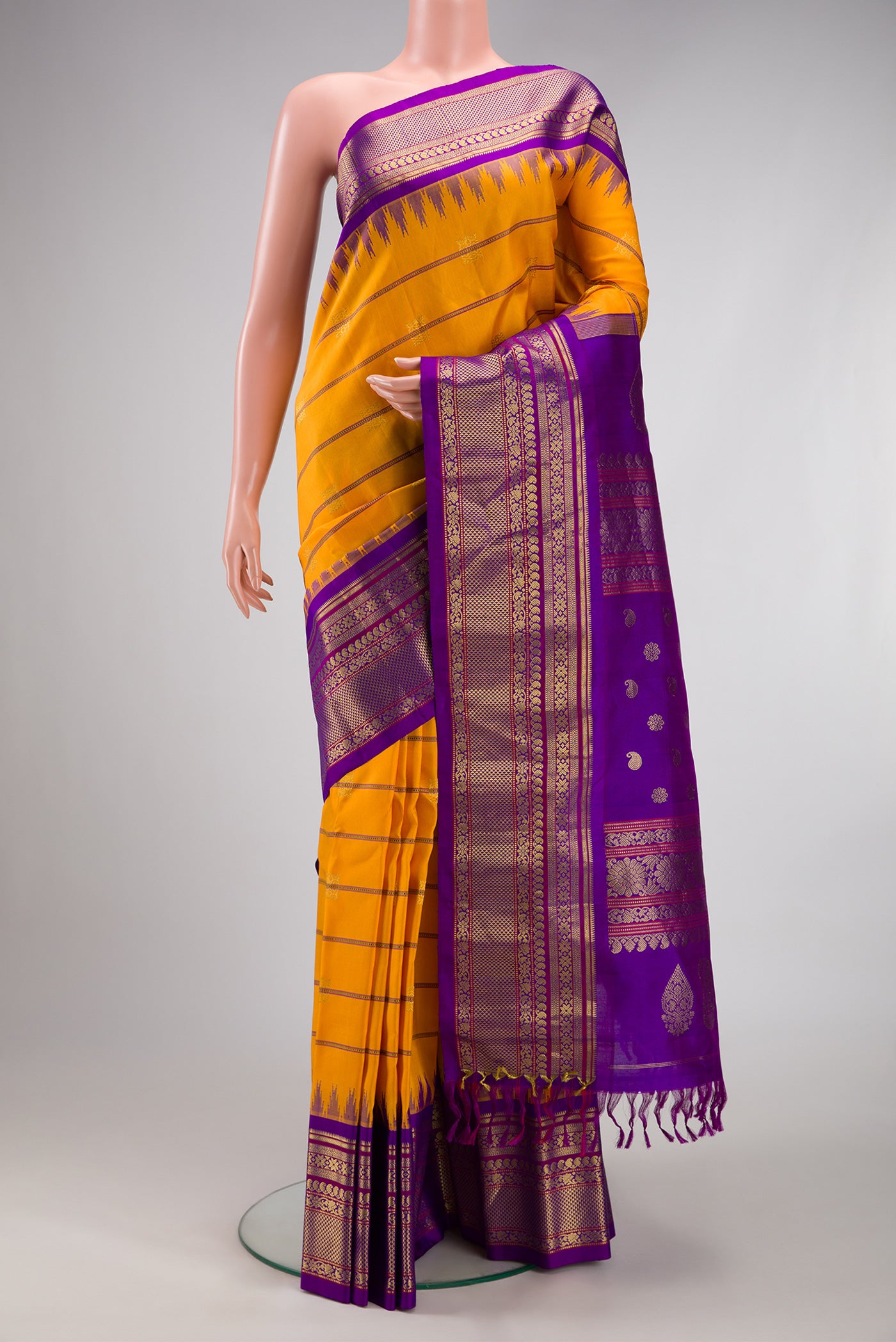 Yellow Gadwal Silk Saree with Stripes on the body and Zari Border.  displayed on a mannequin
