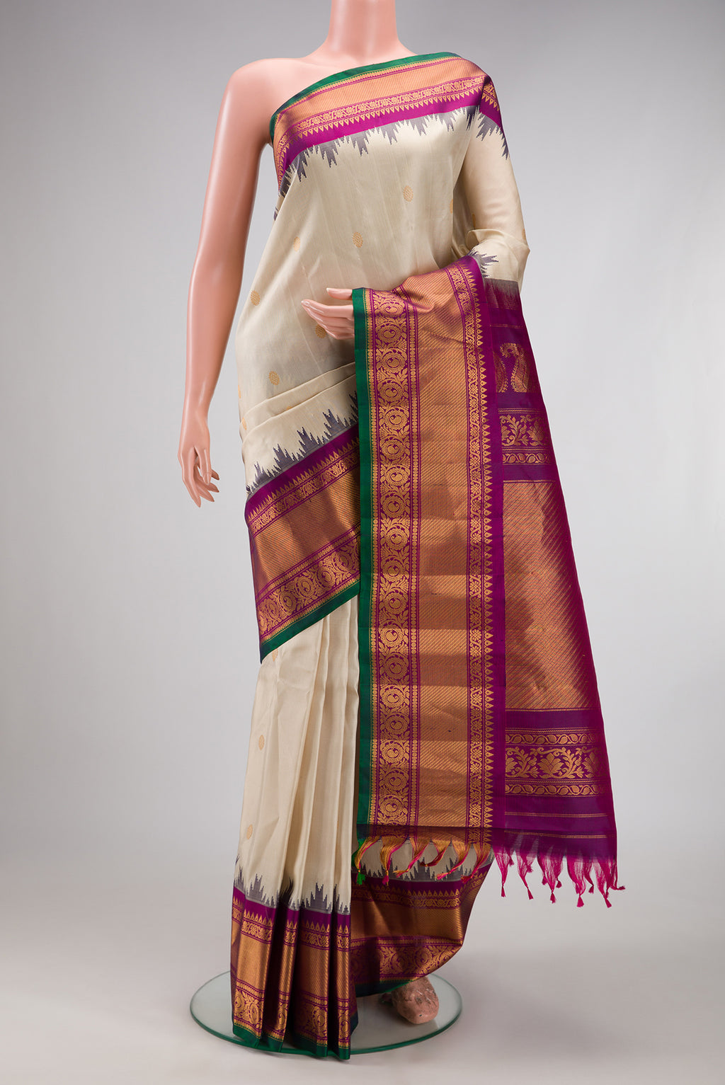 Cream Gadwal Silk Saree with Zari Butta on the body and Zari Border.  displayed on a mannequin