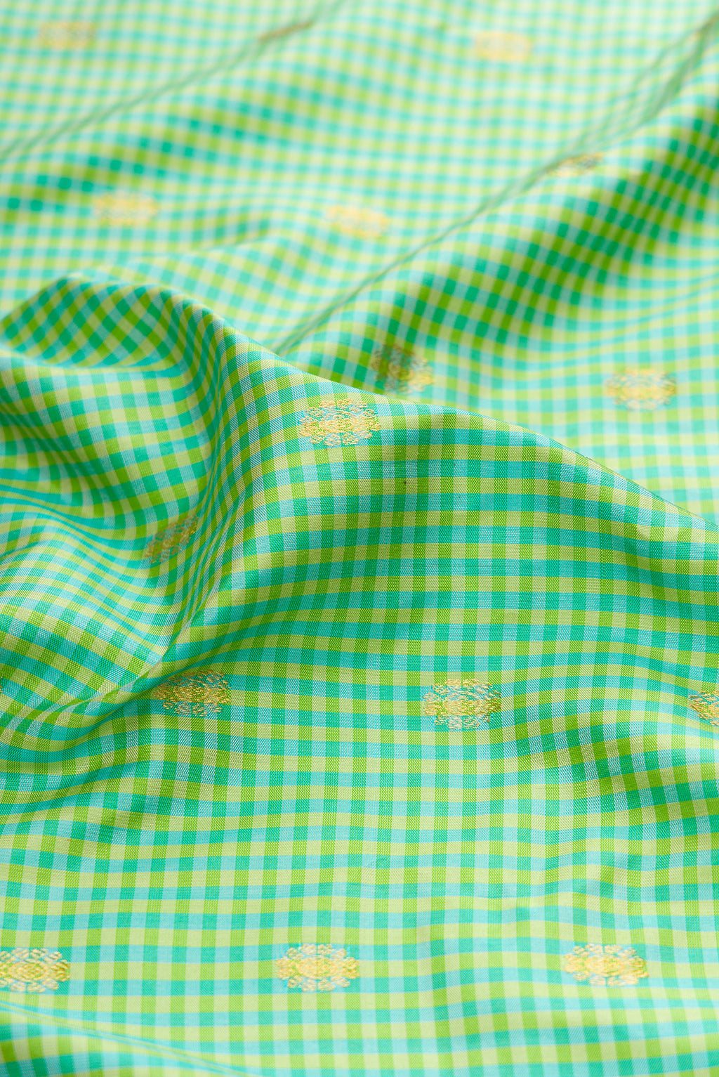 Close up of Sea Green Gadwal Silk Saree with Checked design on the body and Zari Border.  displaying folds