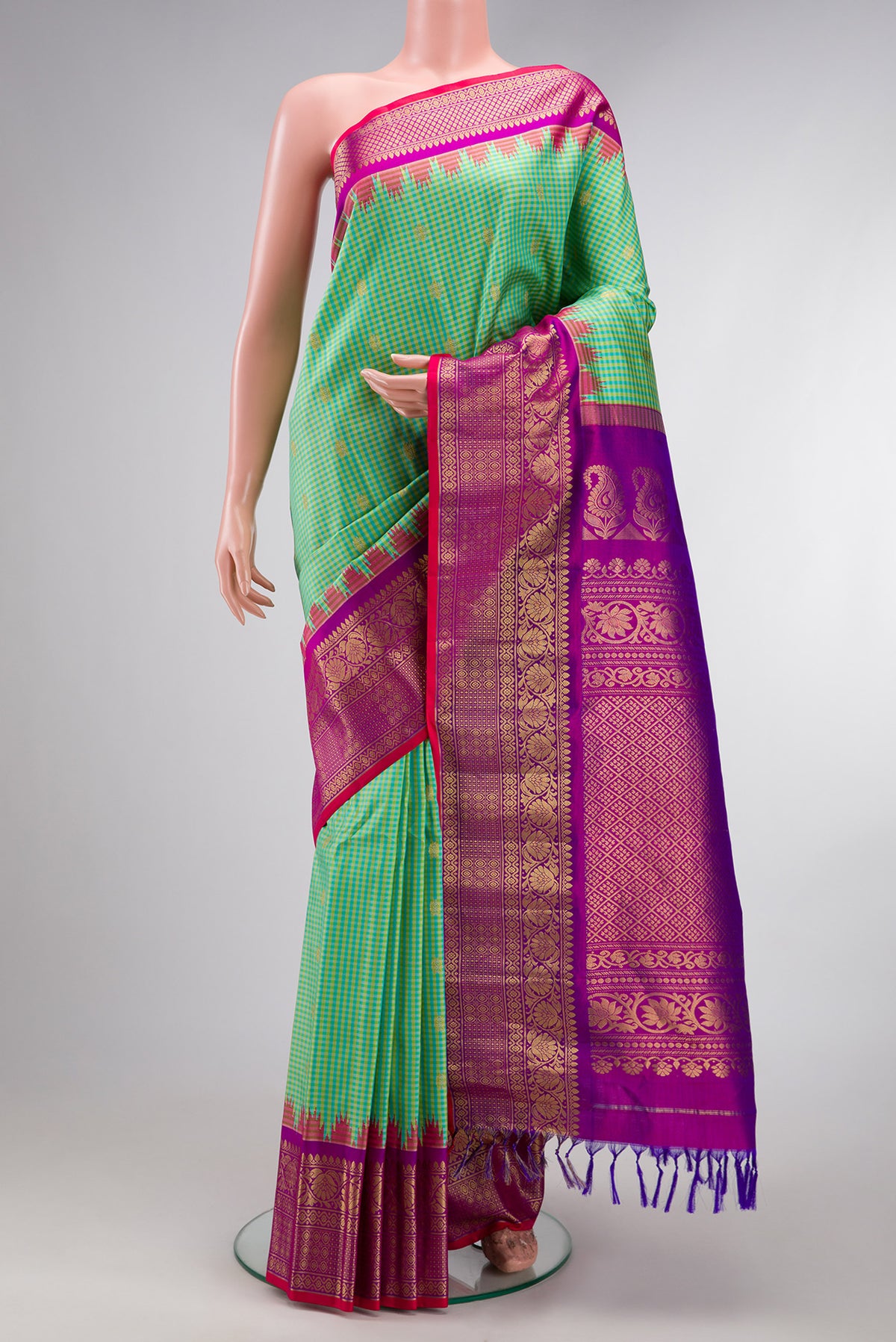 Sea Green Gadwal Silk Saree with Checked design on the body and Zari Border.  displayed on a mannequin