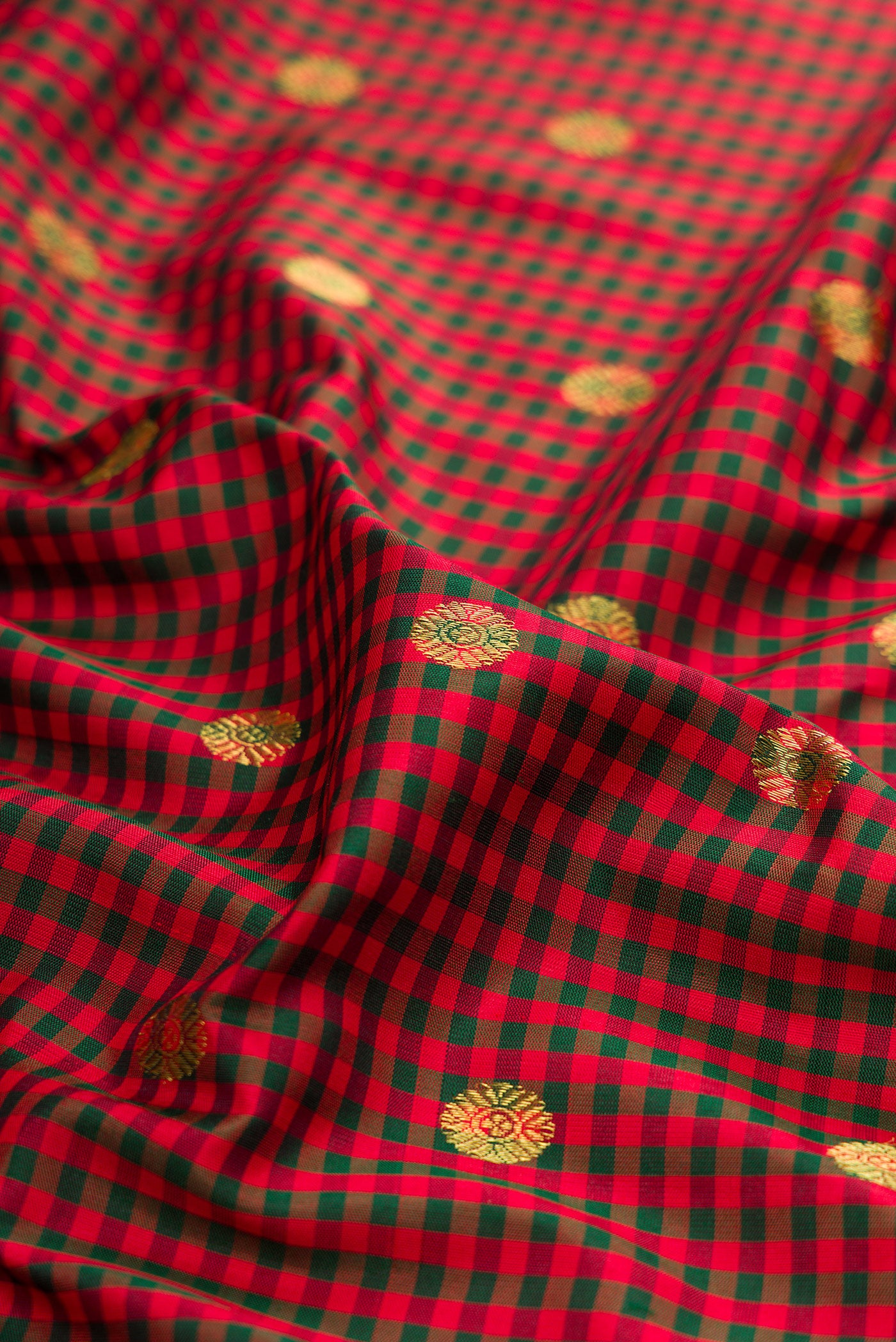 Close up of Maroon Gadwal Silk Saree with Checked design on the body and Zari Border.  displaying folds