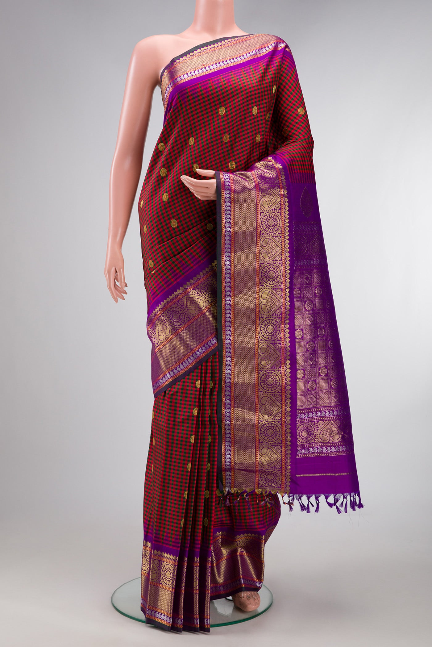 Maroon Gadwal Silk Saree with Checked design on the body and Zari Border.  displayed on a mannequin
