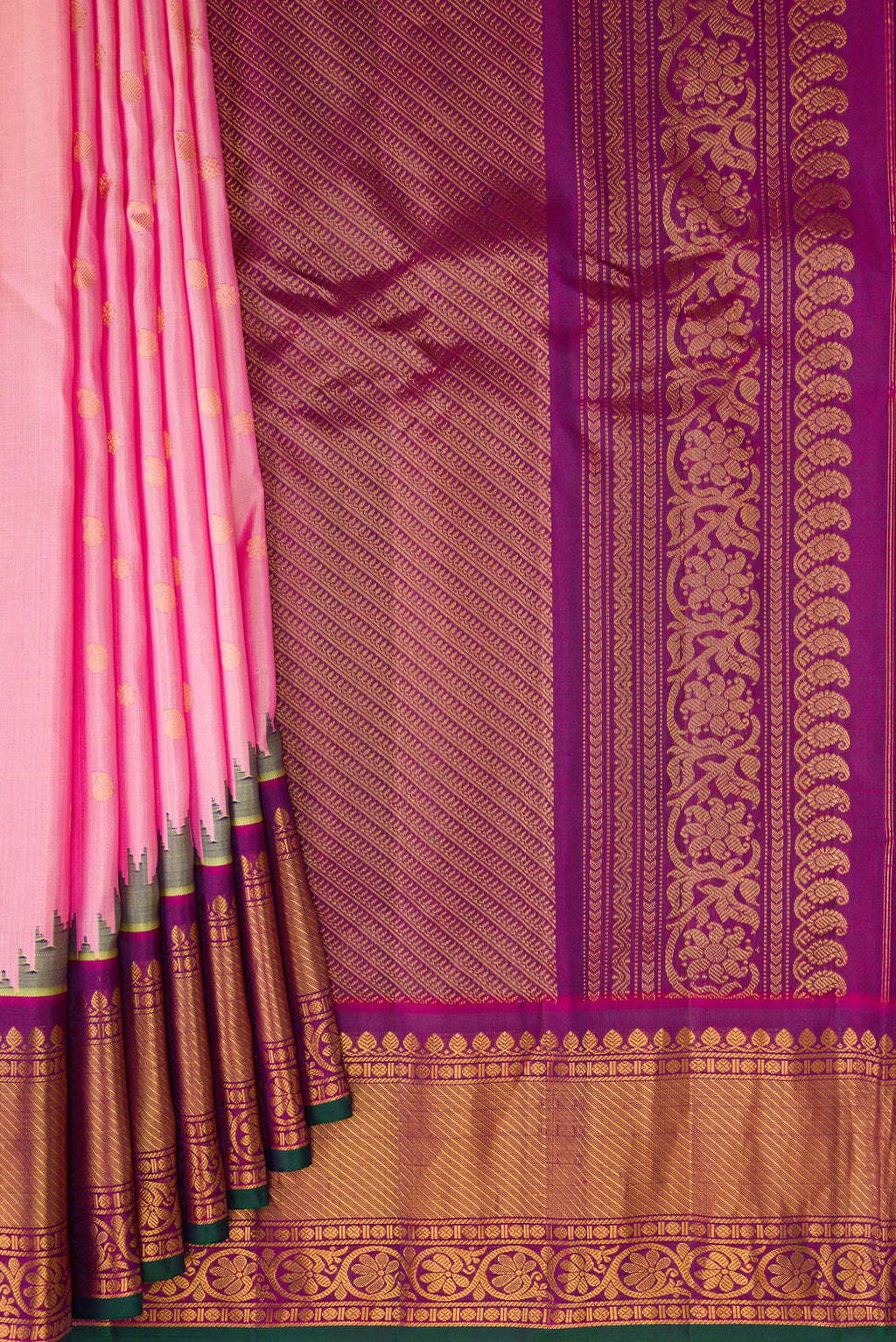 Pleats and pallu of Rose pink Gadwal Silk Saree with Zari Butta on the body and Zari Border. 