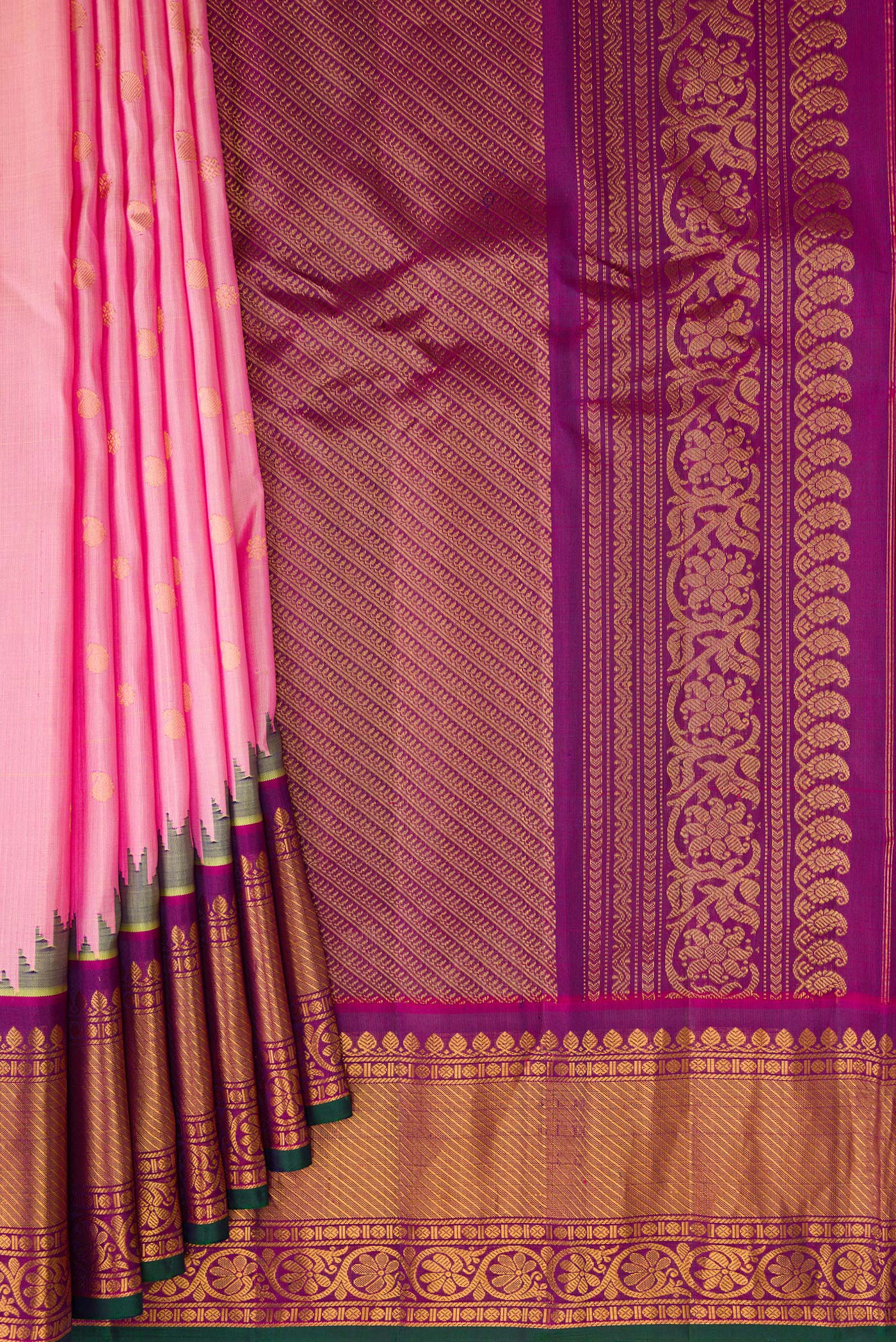 Pleats and pallu of Rose pink Gadwal Silk Saree with Zari Butta on the body and Zari Border. 