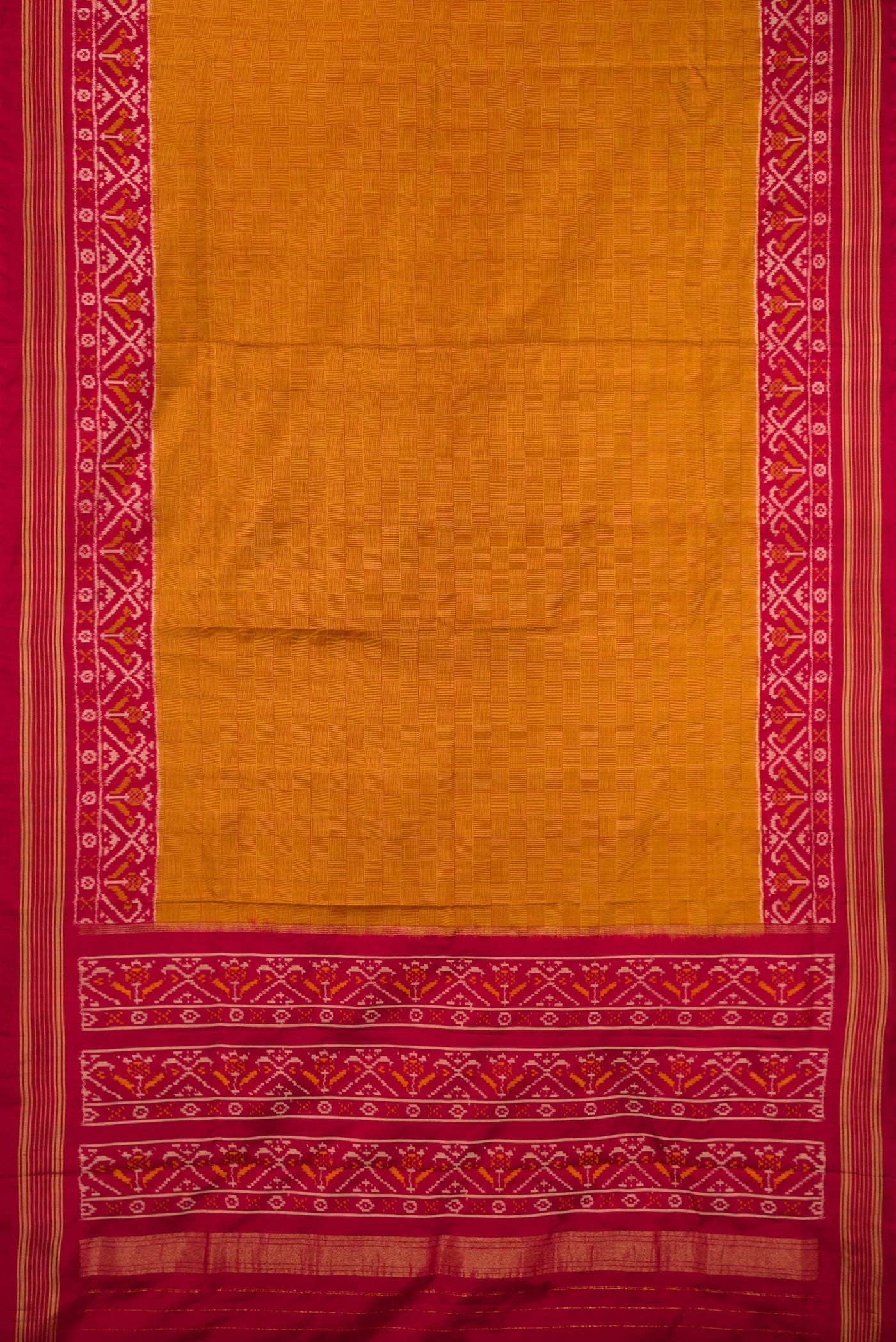 Flat view of Mustard Double Ikat Saree with Checked design on the body and Ikat Border. 