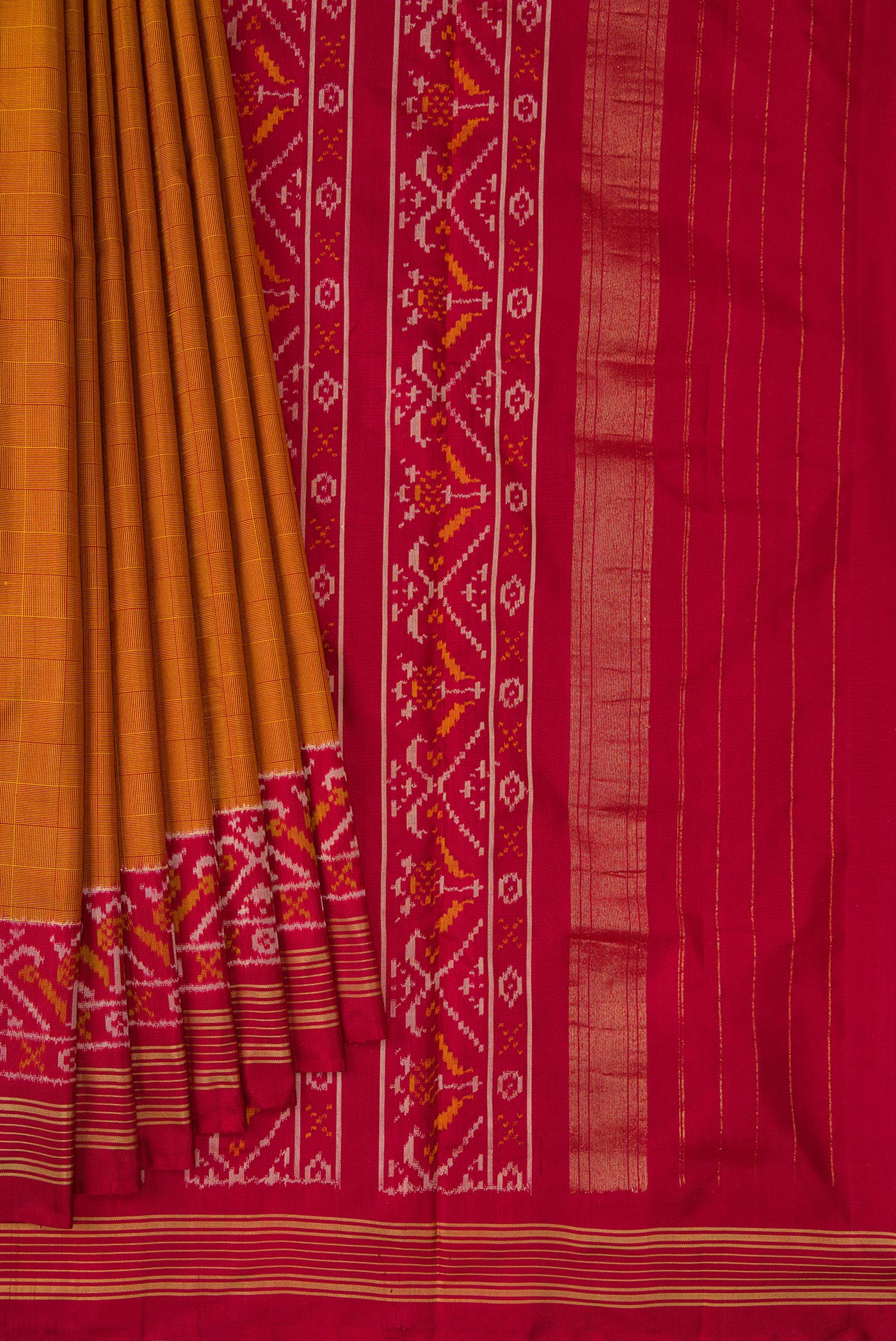 Pleats and pallu of Mustard Double Ikat Saree with Checked design on the body and Ikat Border. 