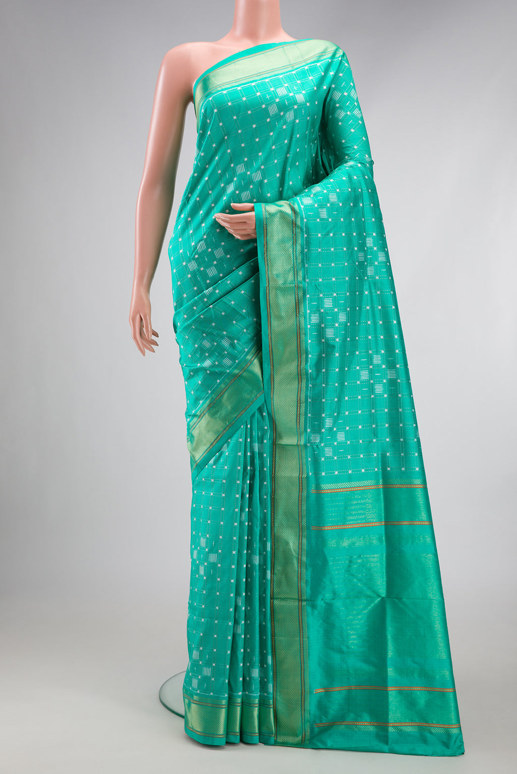 Sea Green Double Ikat Saree with Pure Ikat on the body and Zari Border.  displayed on a mannequin