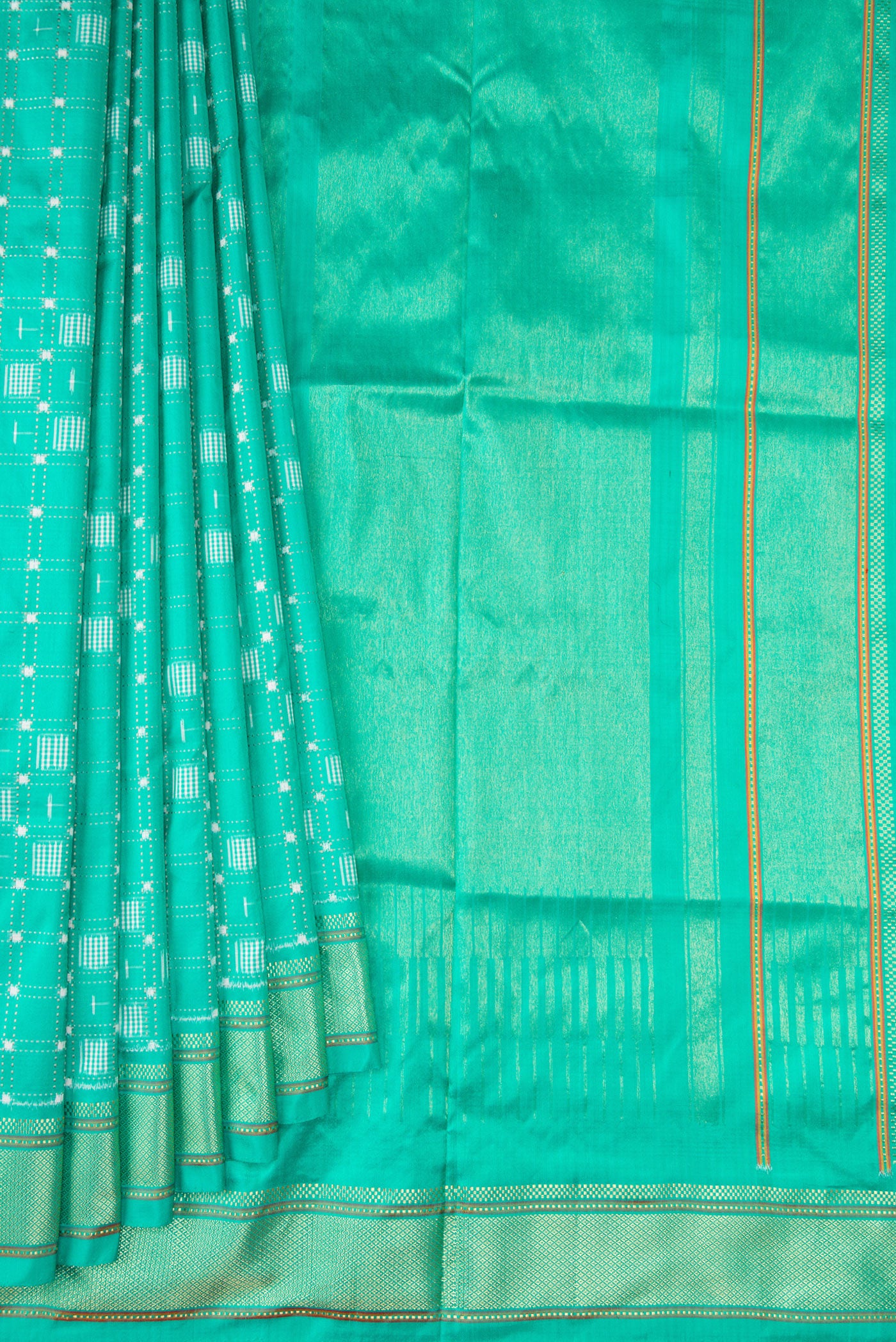 Pleats and pallu of Sea Green Double Ikat Saree with Pure Ikat on the body and Zari Border. 