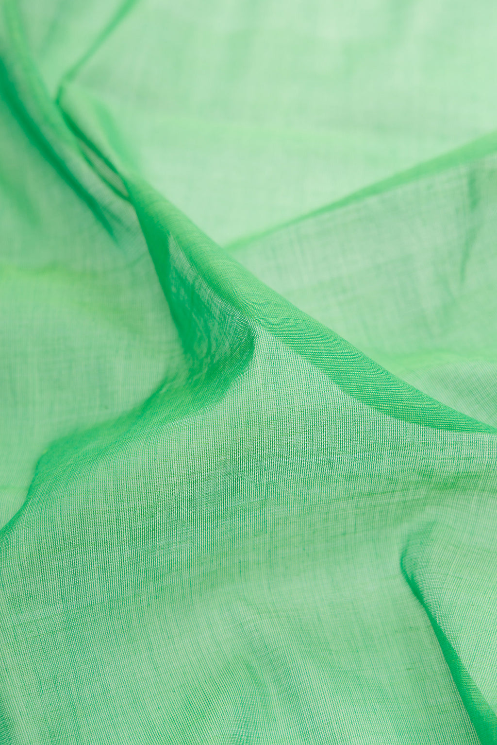 Close up of Green Uppada Cotton Saree with Plain Body and Temple Border.  displaying folds