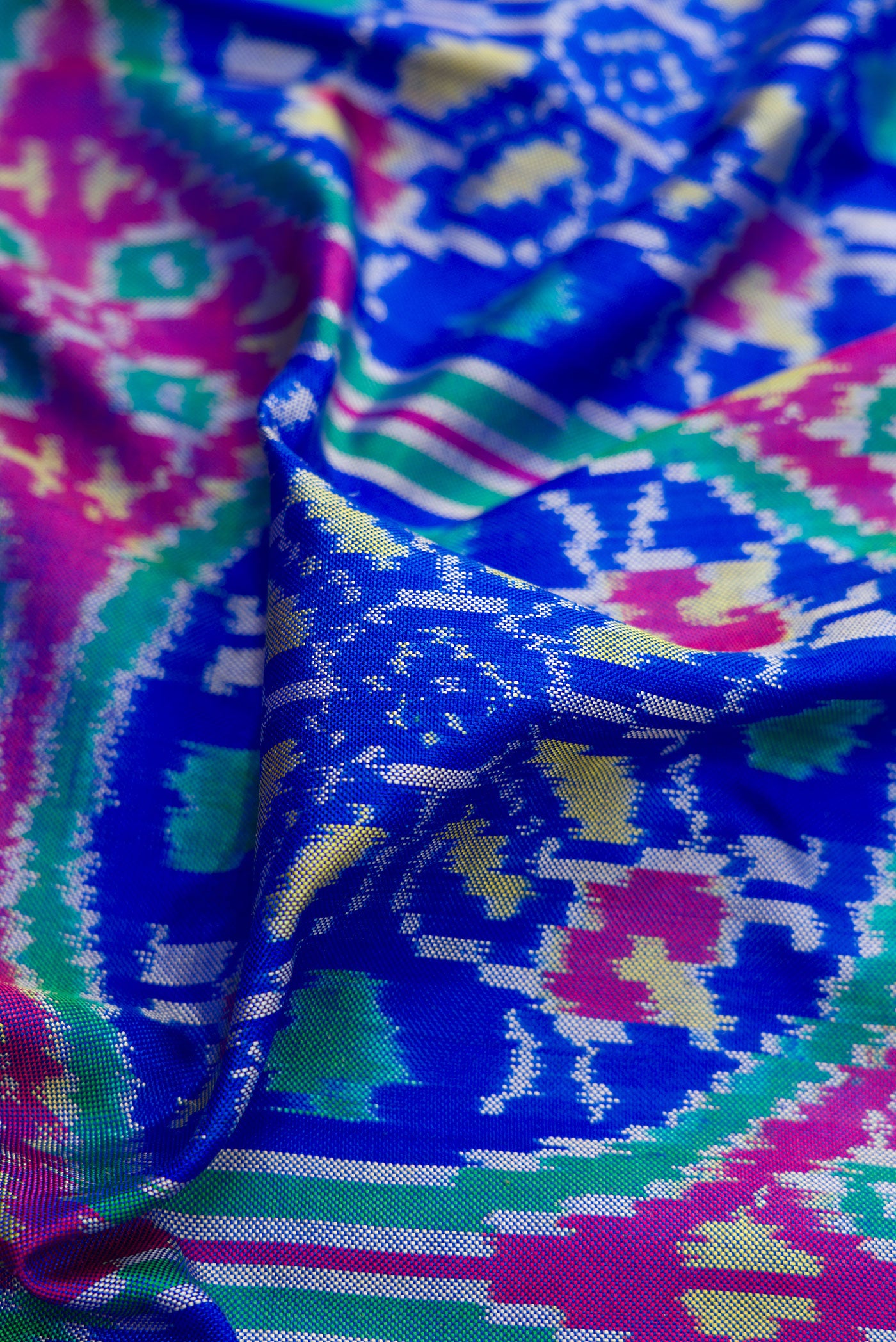Close up of Royal Blue Double Ikat Saree with Pure Ikat on the body and Thread Border.  displaying folds