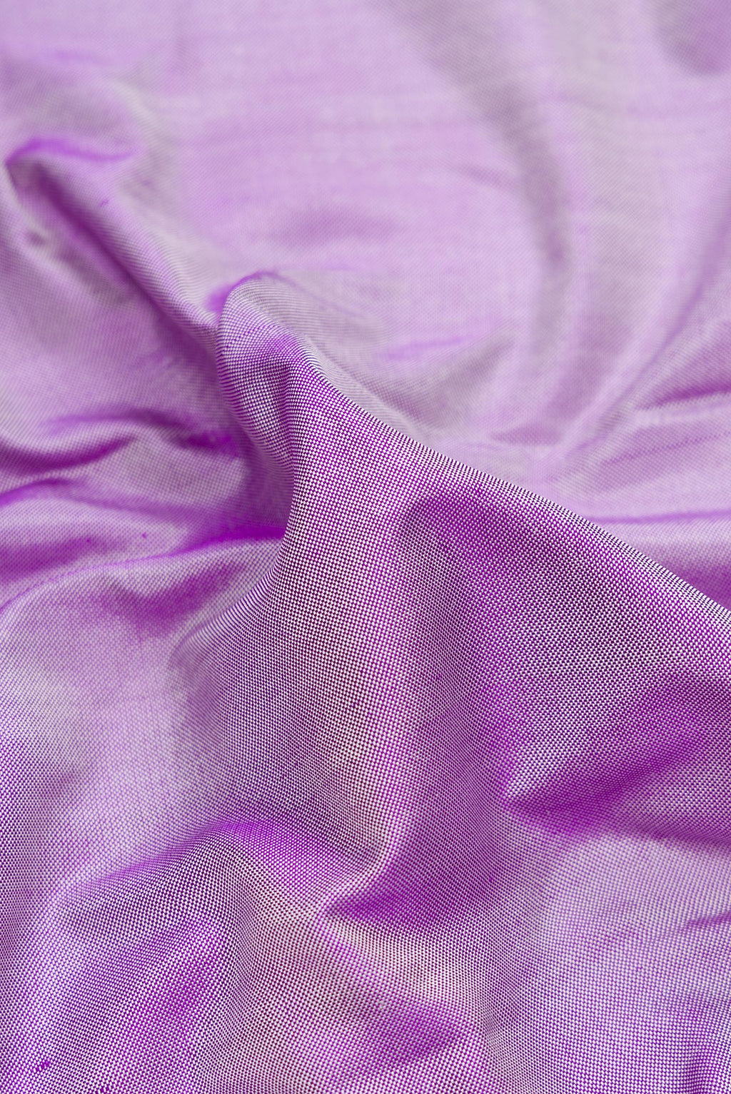 Close up of Pure Silk Lavender Double Ikat Saree with Plain Body and Ikat Border.  displaying folds