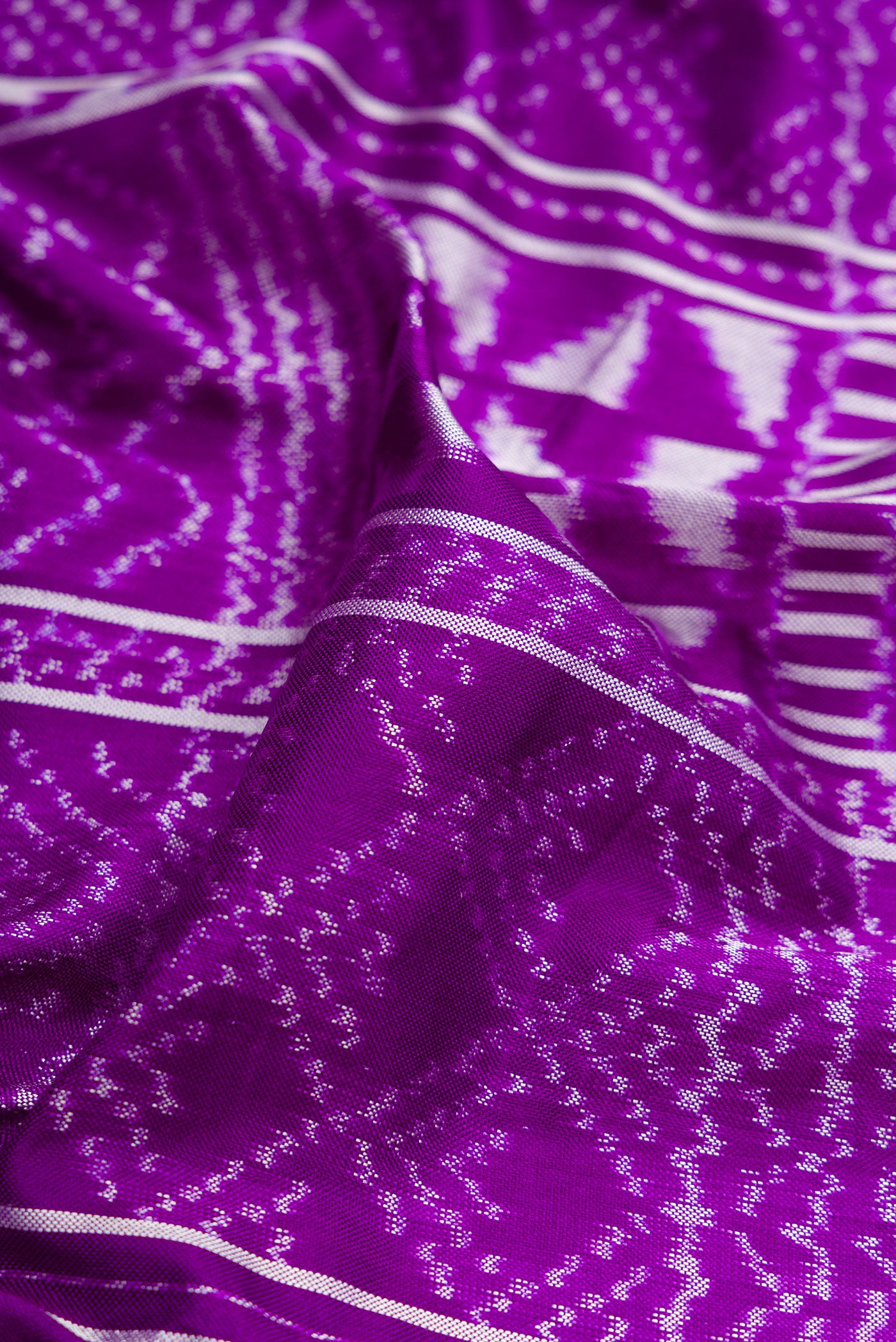 Close up of Violet Double Ikat Saree with Pure Ikat on the body and Plain Border.  displaying folds