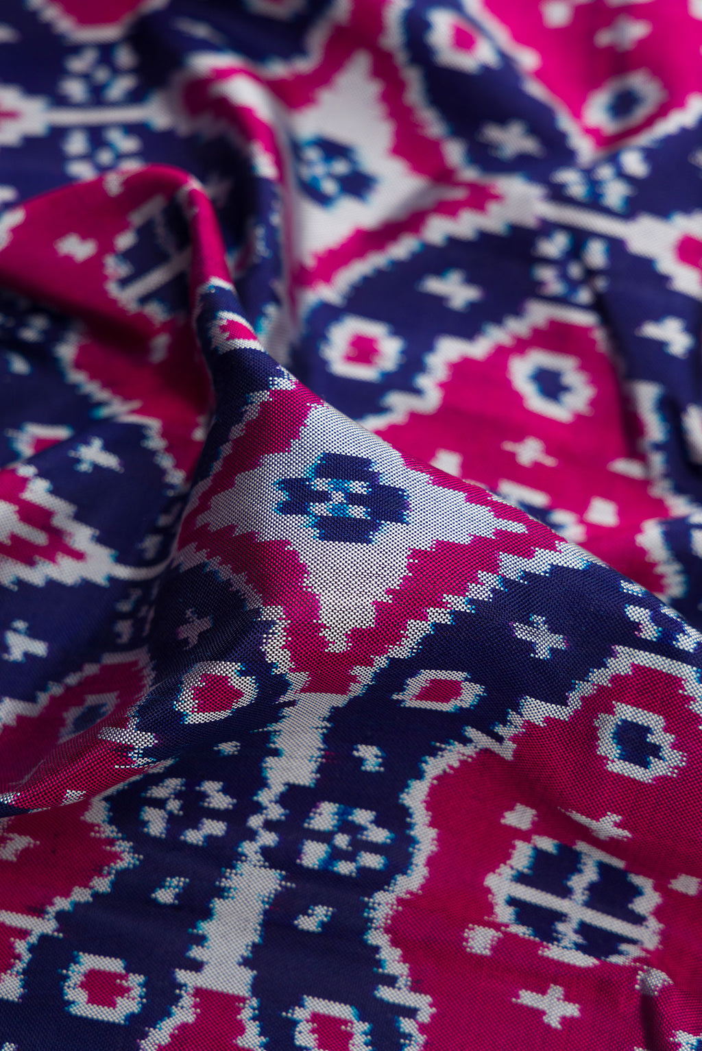 Close up of Navy Blue Double Ikat Saree with Pure Ikat on the body and Plain Border.  displaying folds