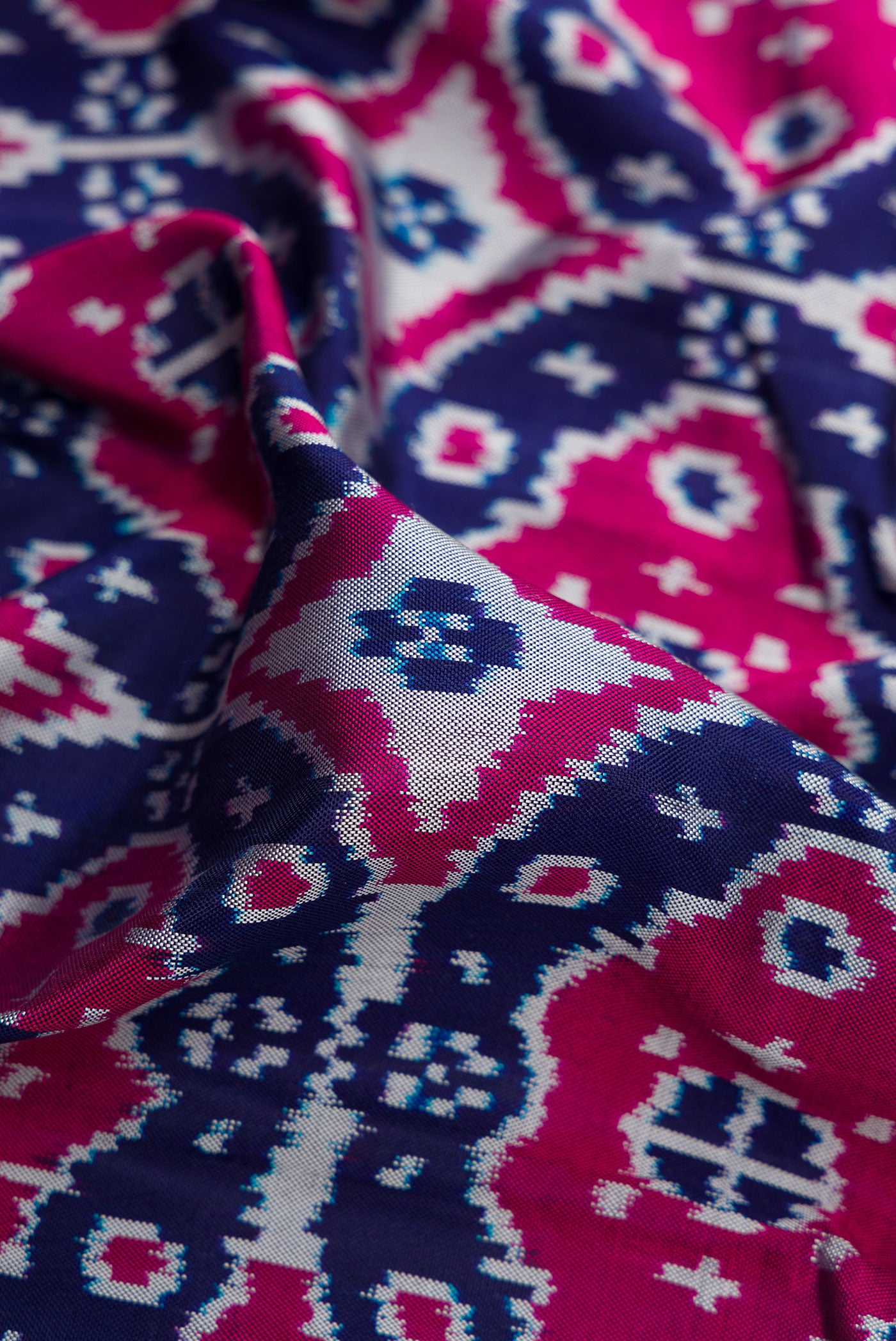 Close up of Navy Blue Double Ikat Saree with Pure Ikat on the body and Plain Border.  displaying folds
