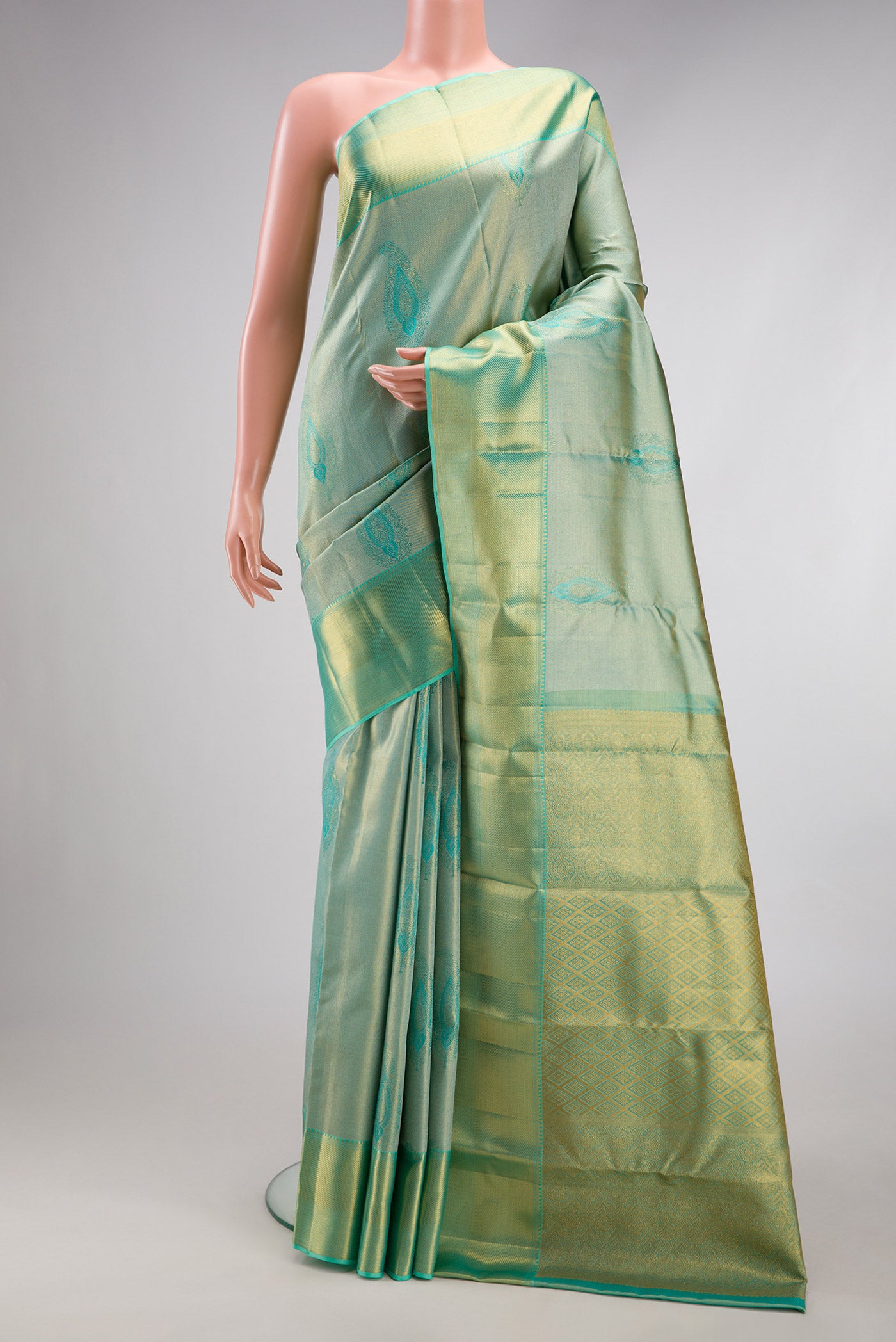 Sea Green Dual Tone Kanchipuram Tissue Silk Saree with Zari Brocade on the body and Zari Border.  displayed on a mannequin